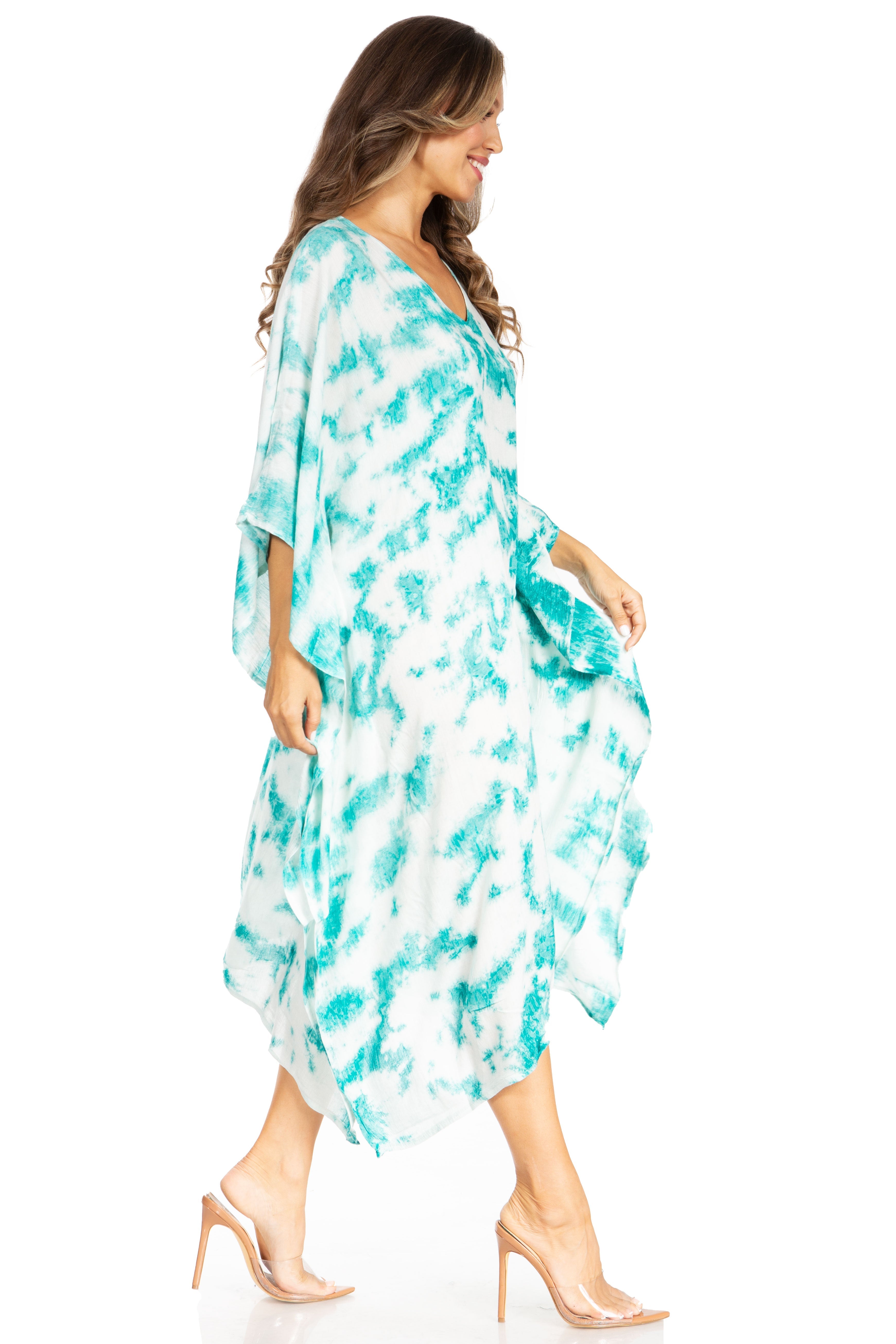 Woman wearing a turquoise and white patterned dress on a white background