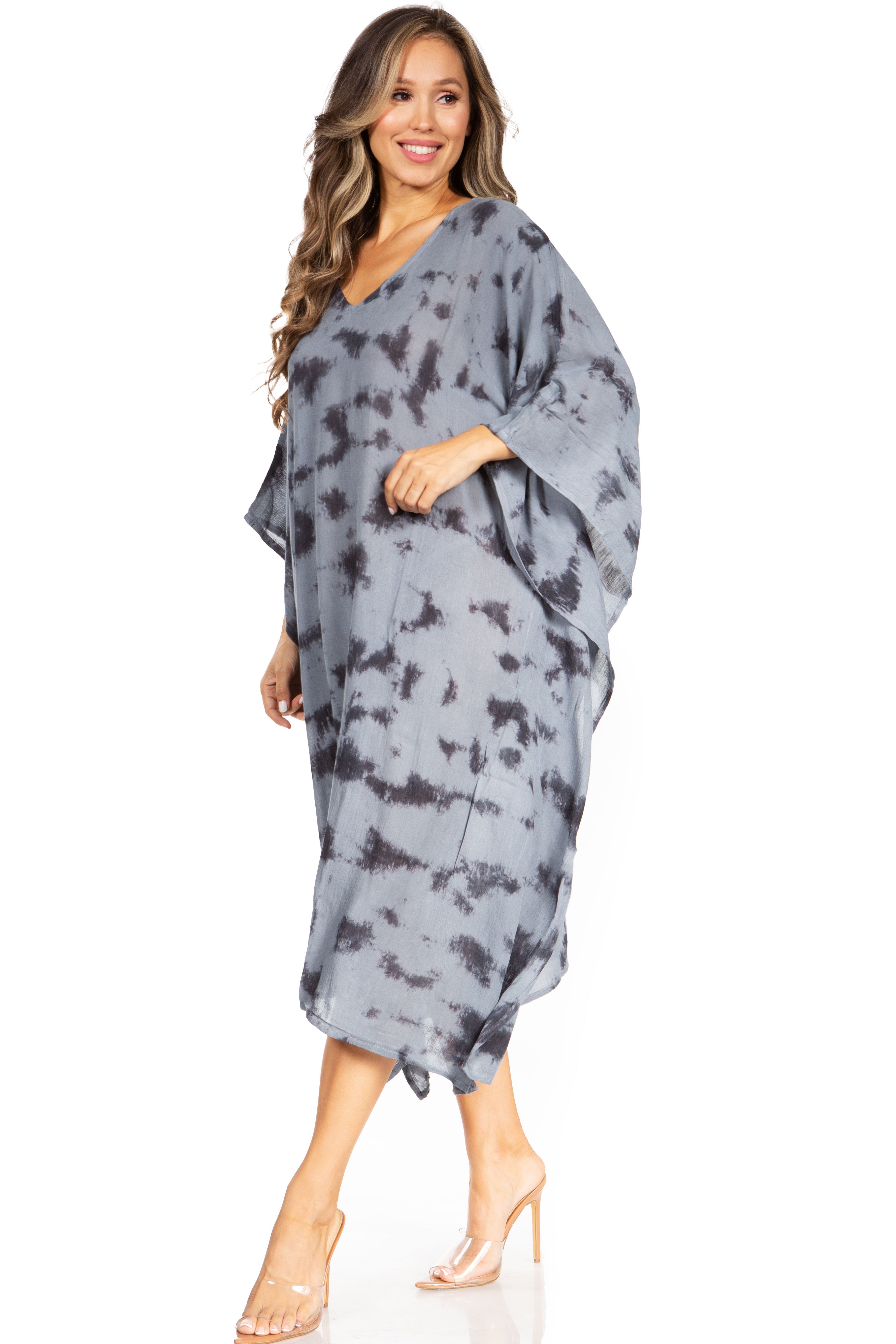 Woman wearing a gray tie-dye dress on a white background