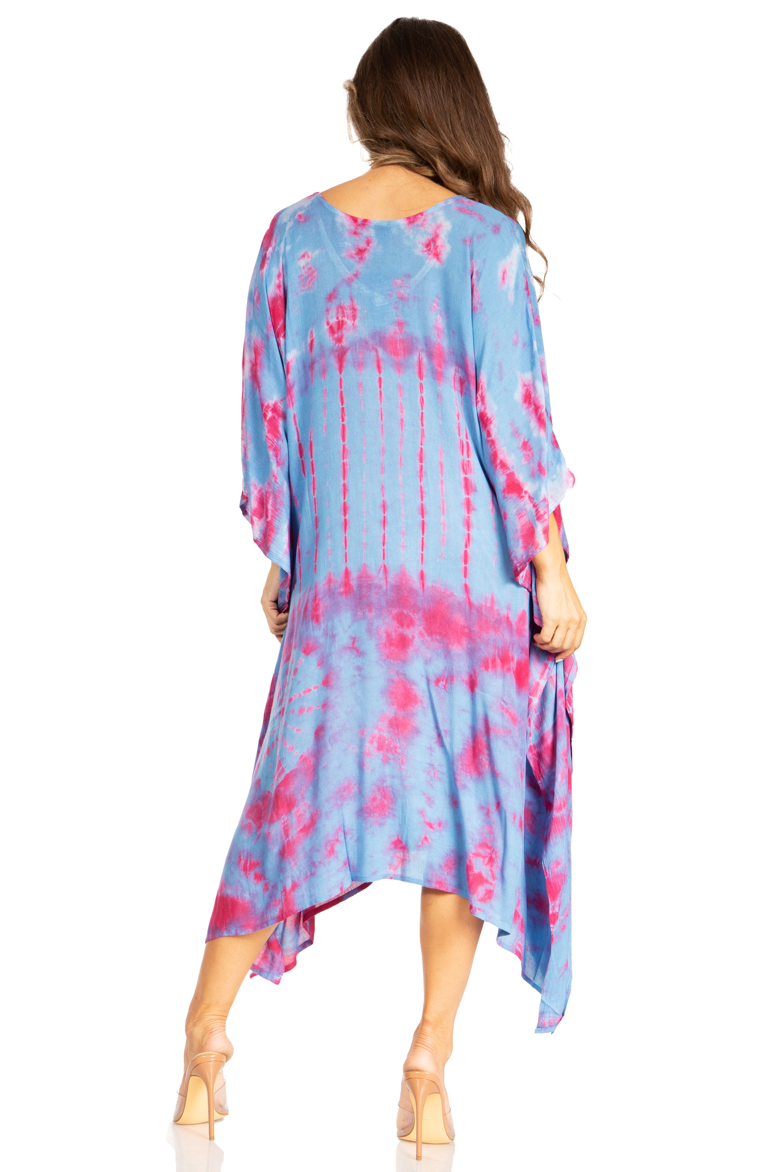 Woman wearing a tie-dye dress with pink and blue patterns on a white background