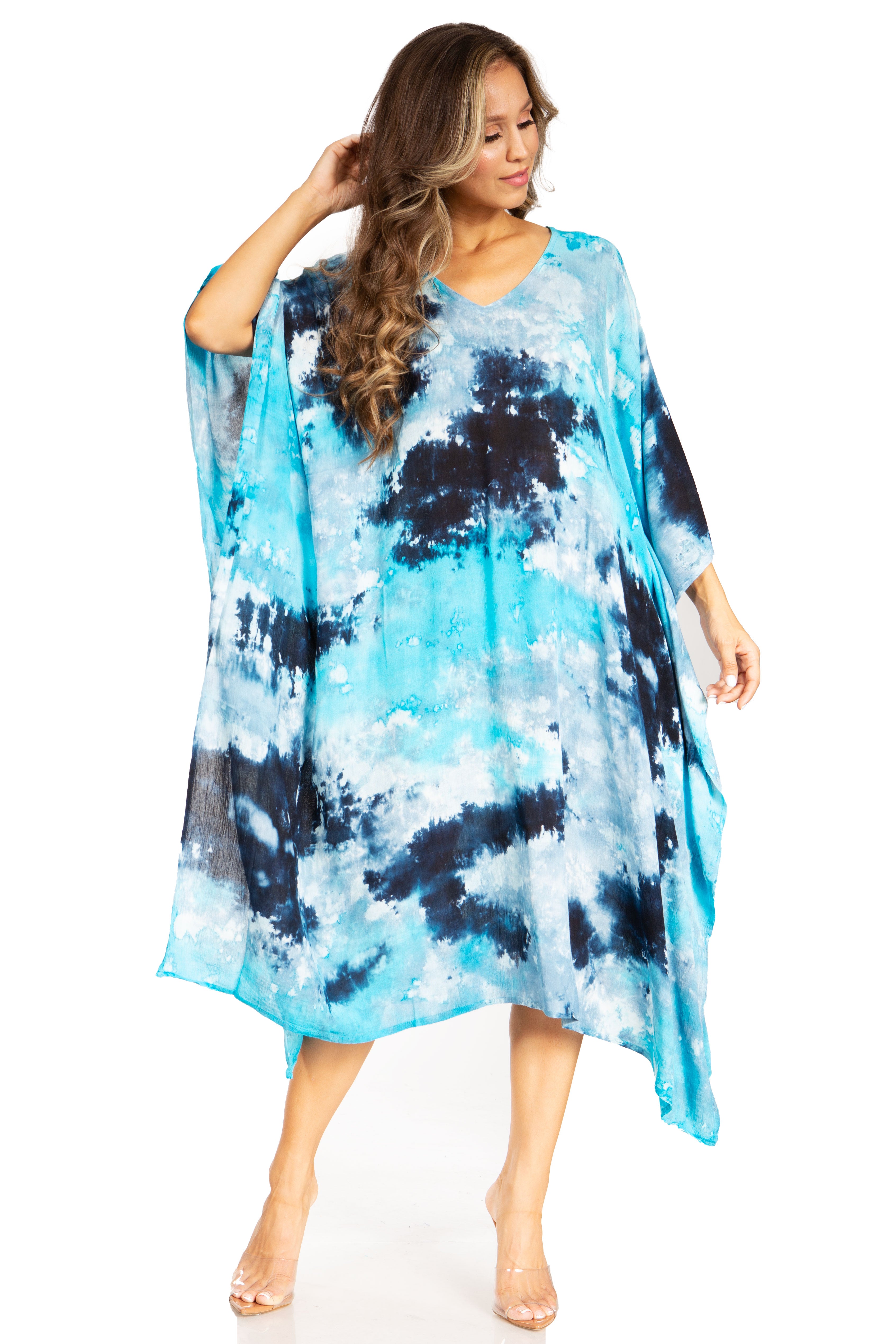 Woman wearing a blue and black tie-dye dress on a white background