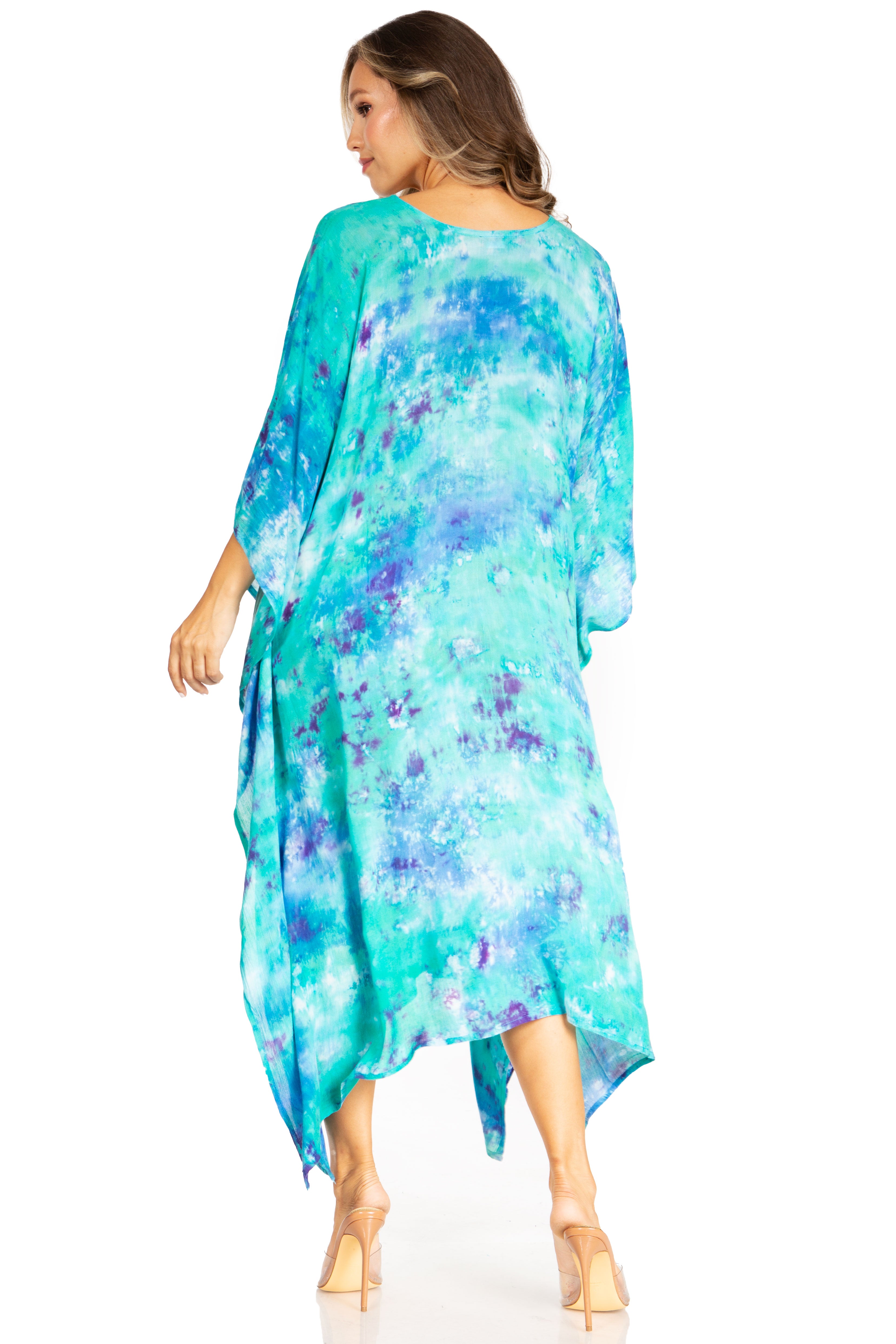 Woman wearing a blue and green patterned dress on a white background