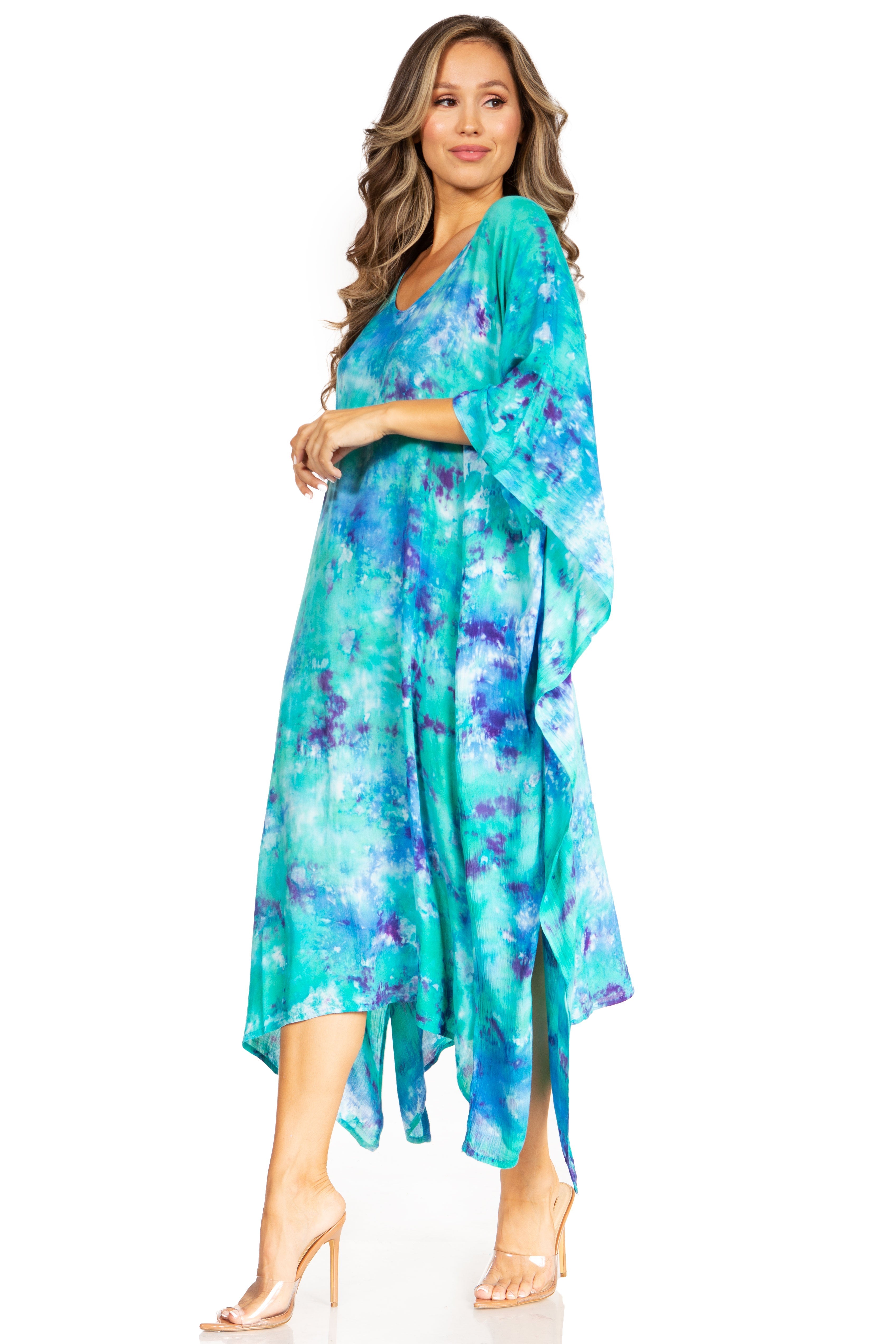 Woman wearing a teal floral dress on a white background