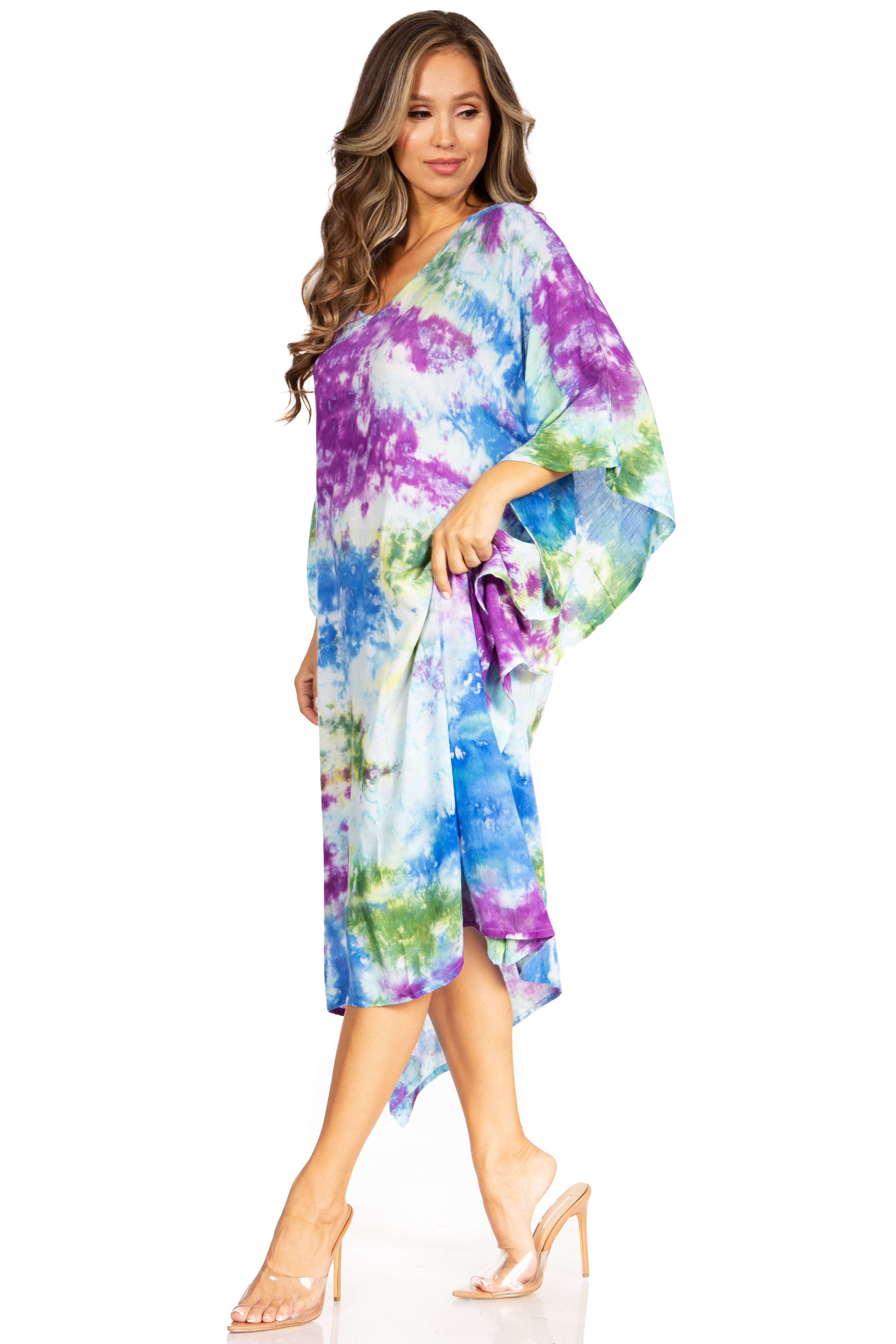 Woman wearing a colorful tie-dye dress on a white background
