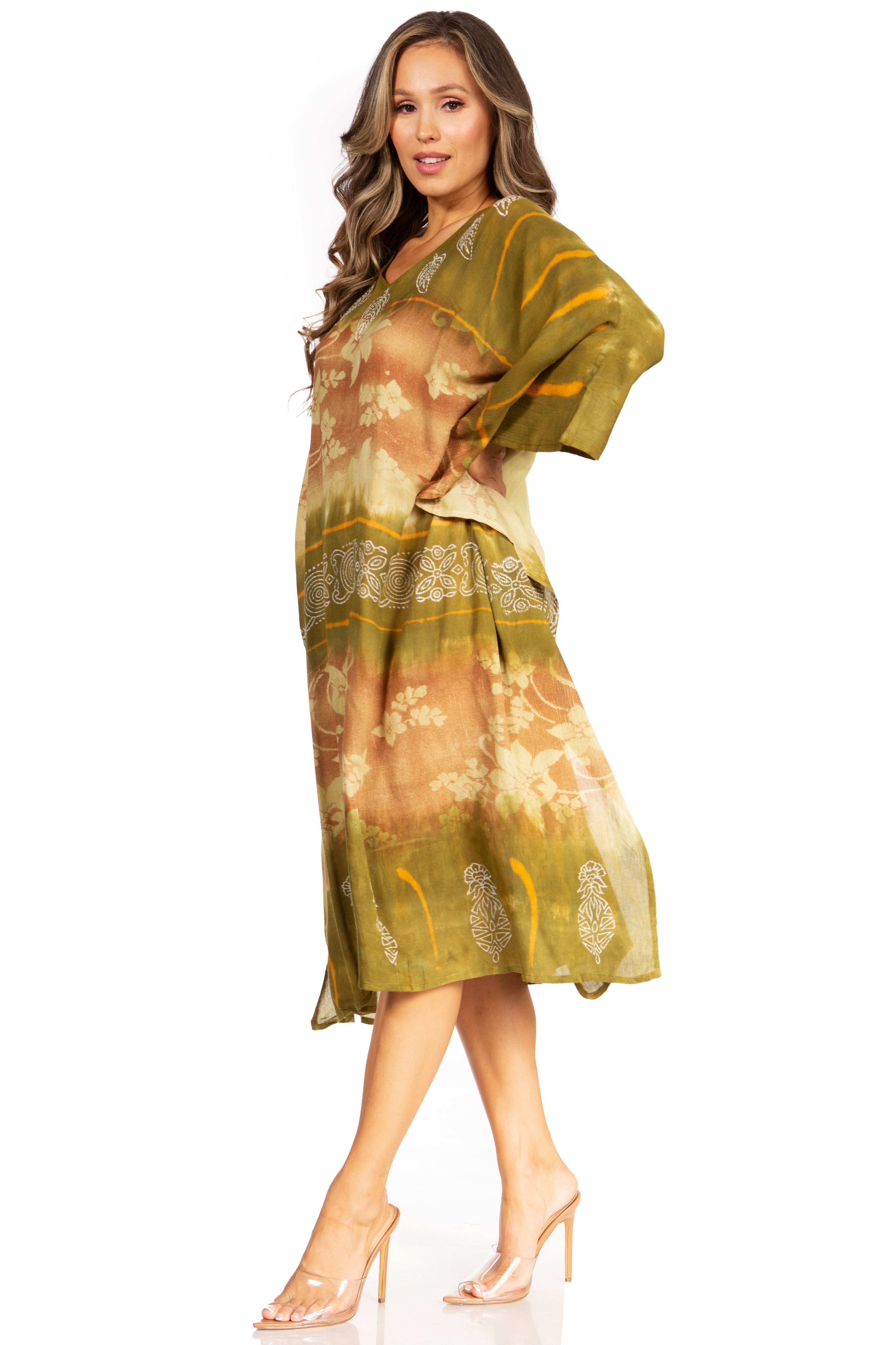Woman wearing a green and brown patterned dress on a white background