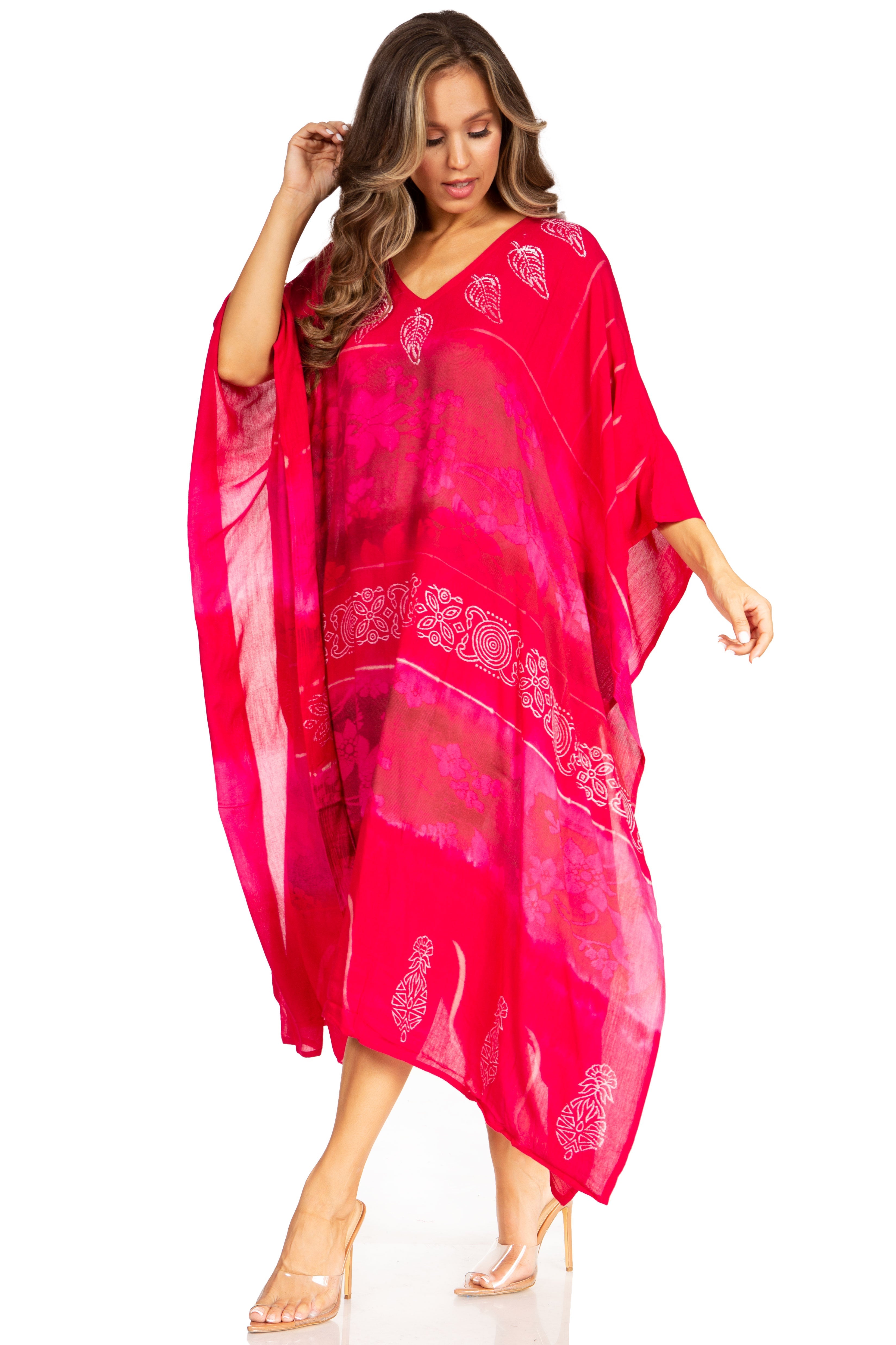 Woman wearing a bright pink caftan with white patterns on a white background