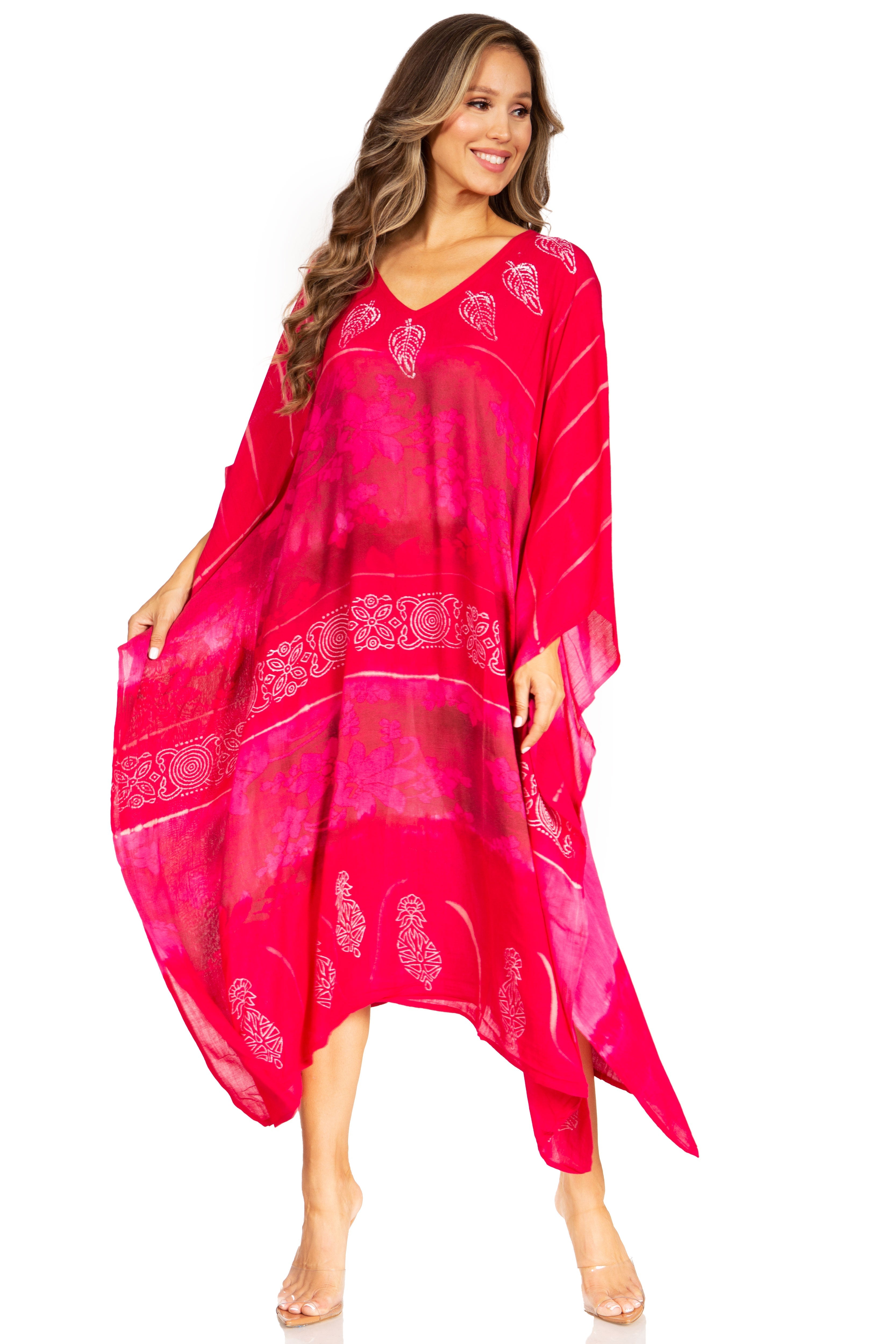 Woman wearing a bright pink dress with white patterns on a white background