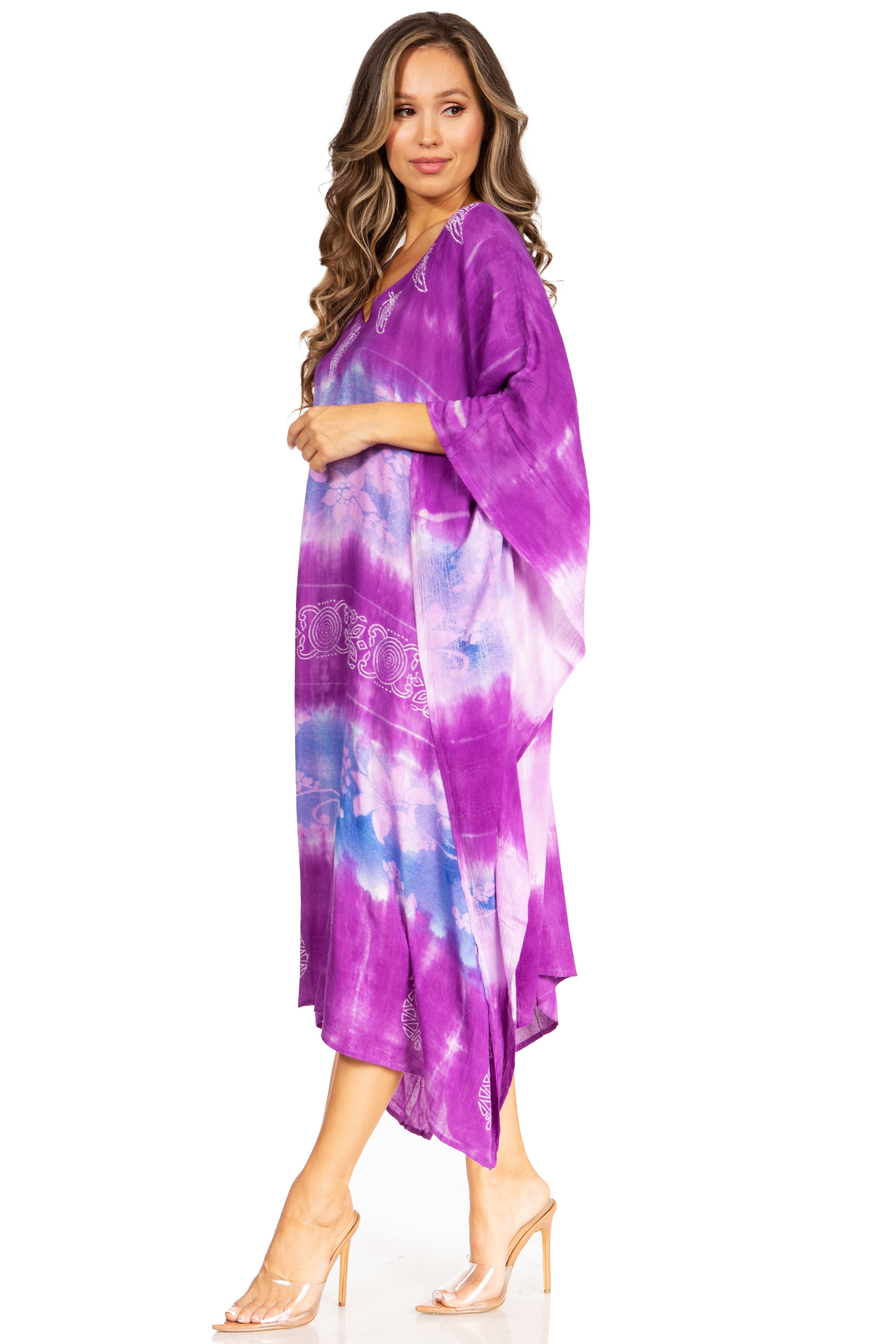 Woman wearing a purple tie-dye dress on a white background