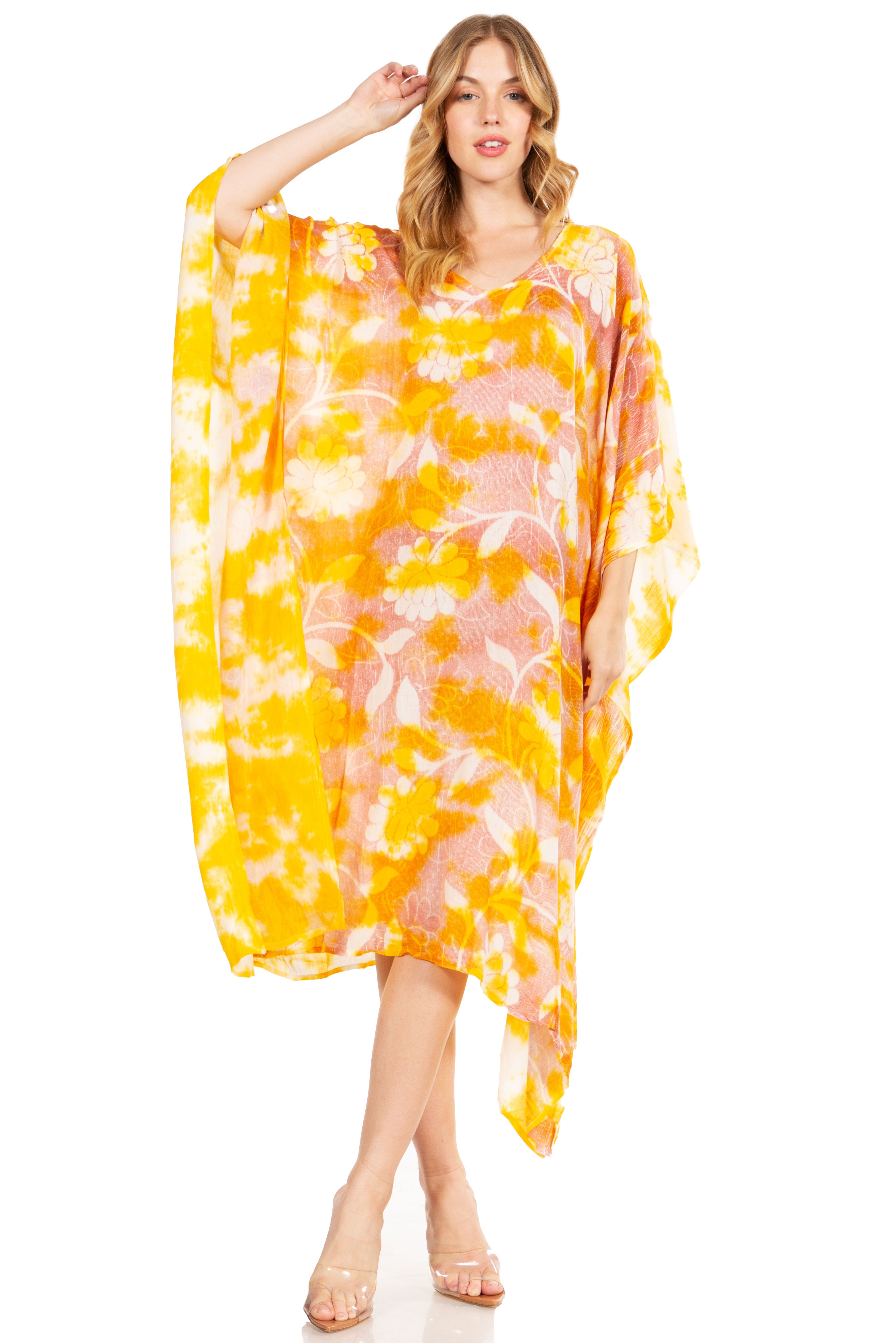 Woman wearing a yellow and pink patterned kaftan on a white background