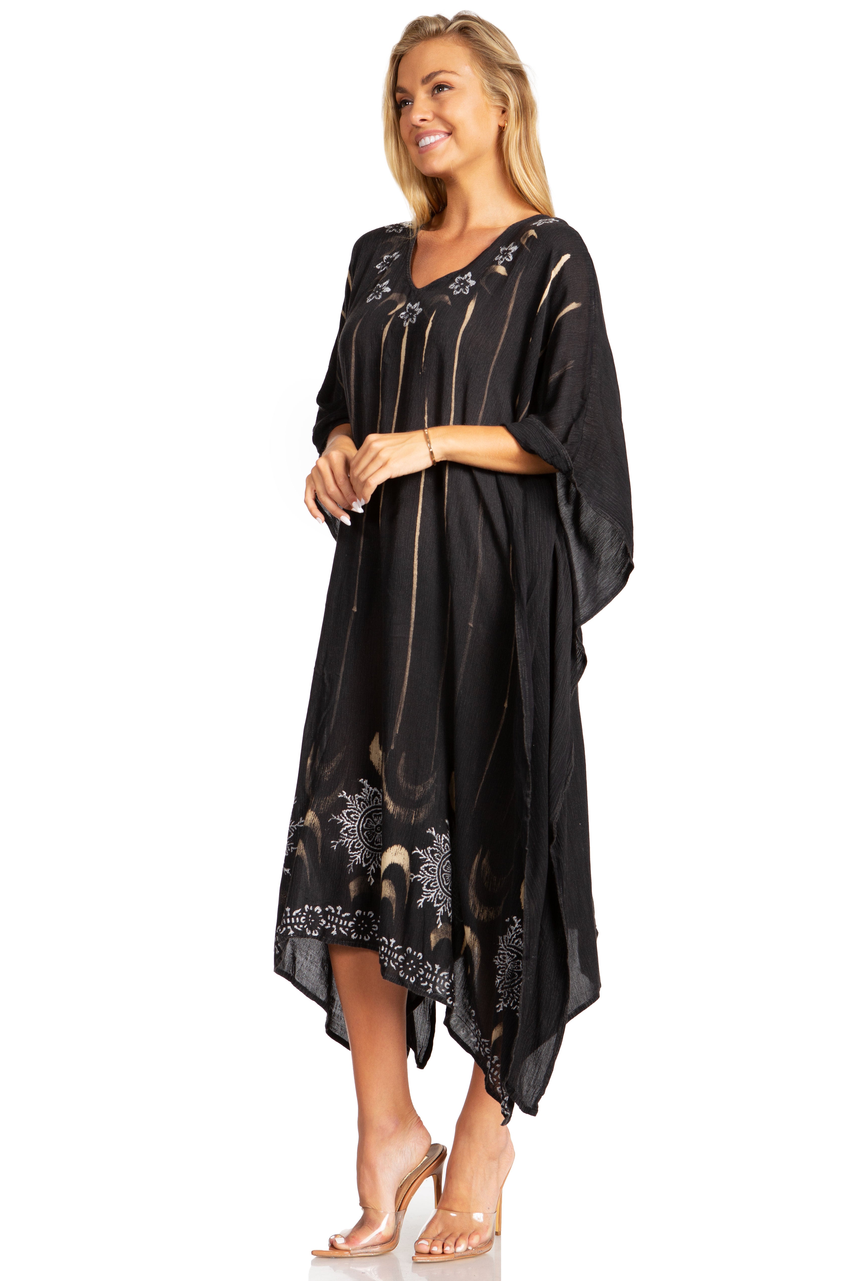 Woman wearing a black dress with floral embroidery on a white background