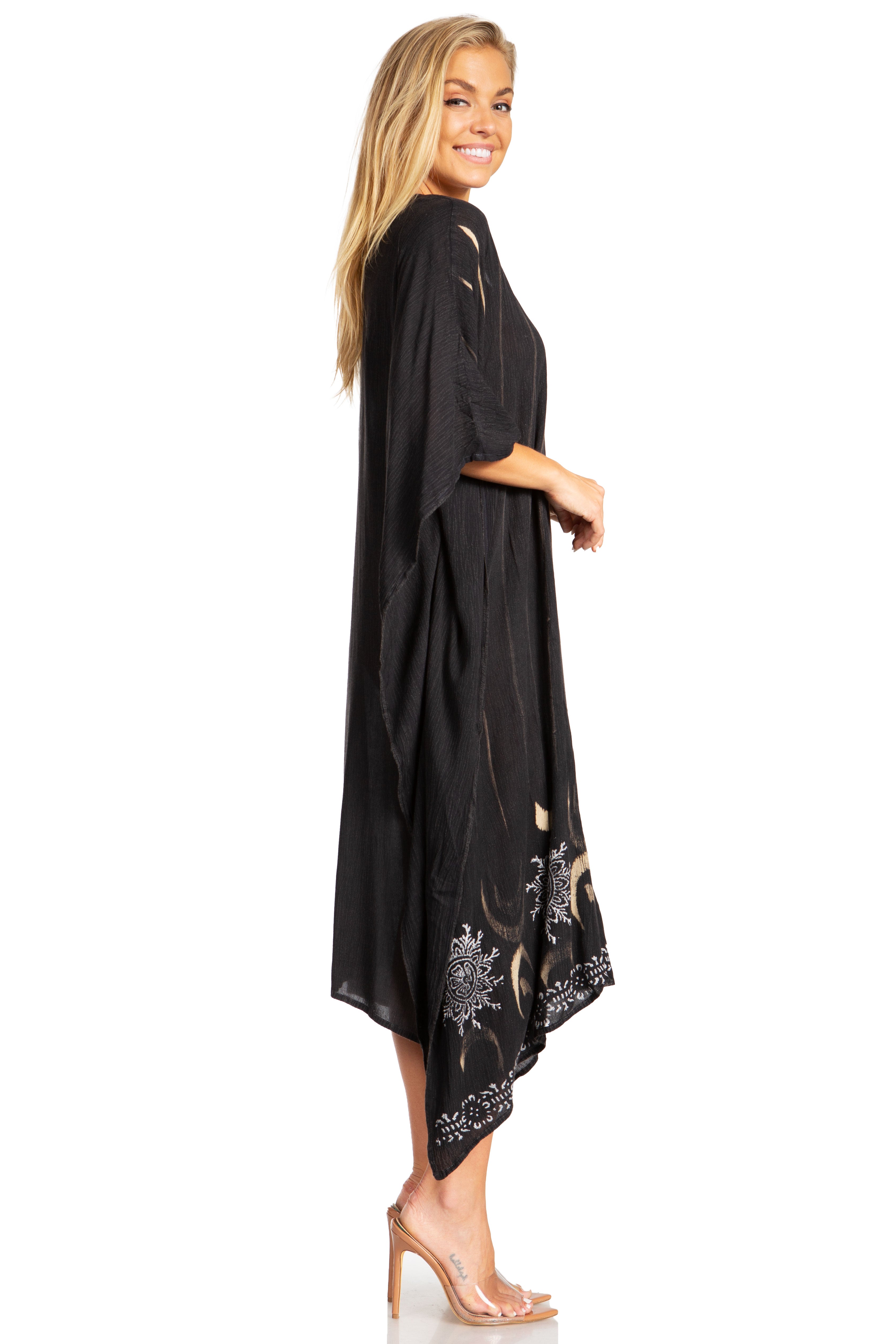 Woman wearing a black dress with floral embroidery on a white background
