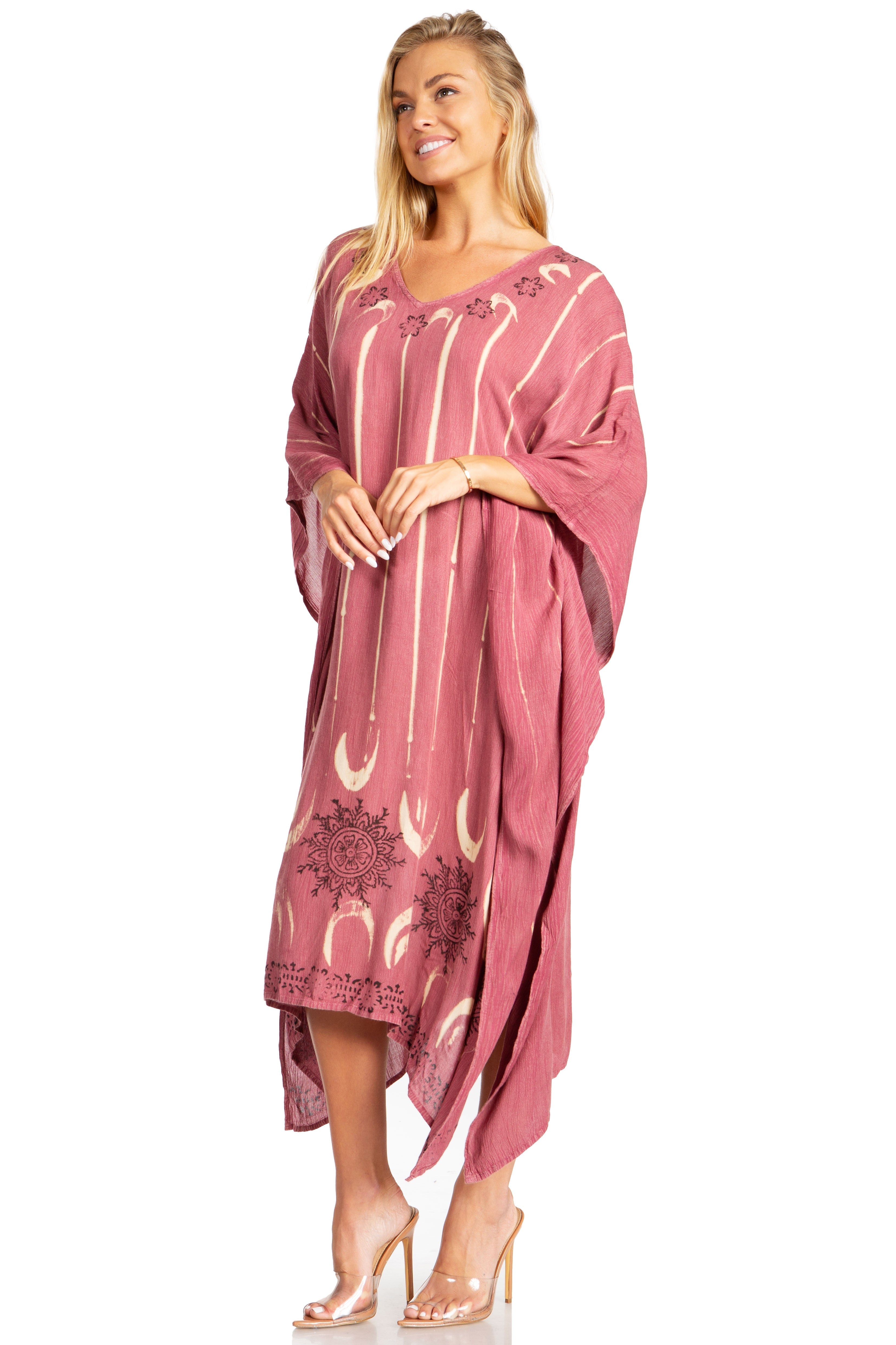 Woman wearing a pink dress with white patterns on a white background