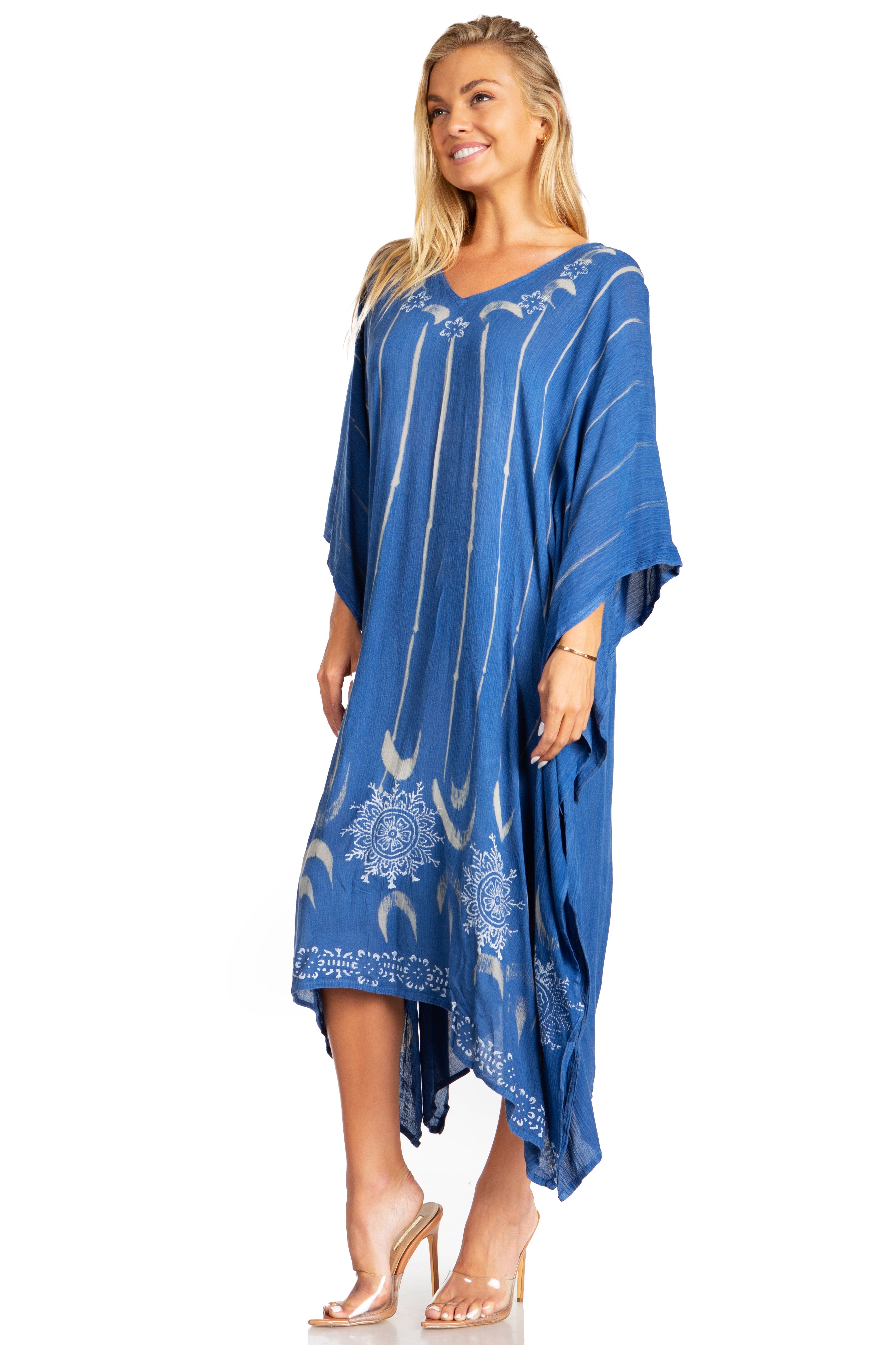 Woman wearing a blue dress with white patterns on a white background