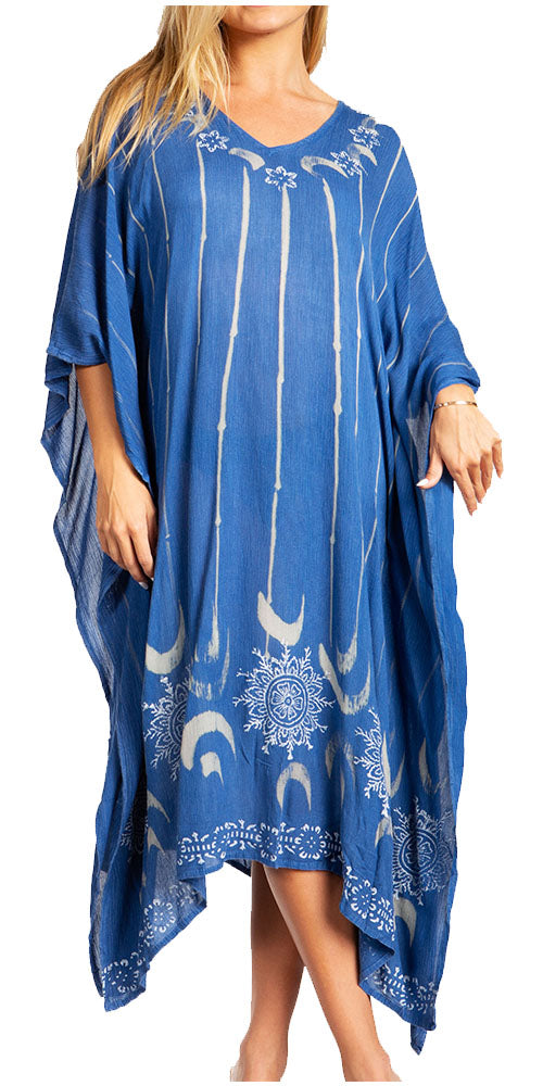 Blue dress with white patterns worn by a model on a white background