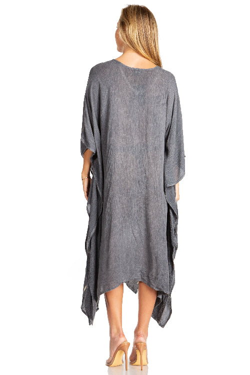 Woman wearing a gray oversized dress on a white background