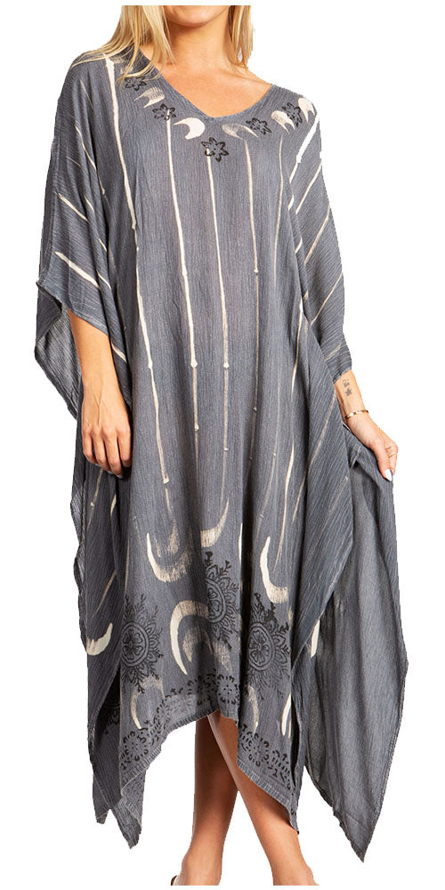 Woman wearing a gray poncho with moon patterns on a white background