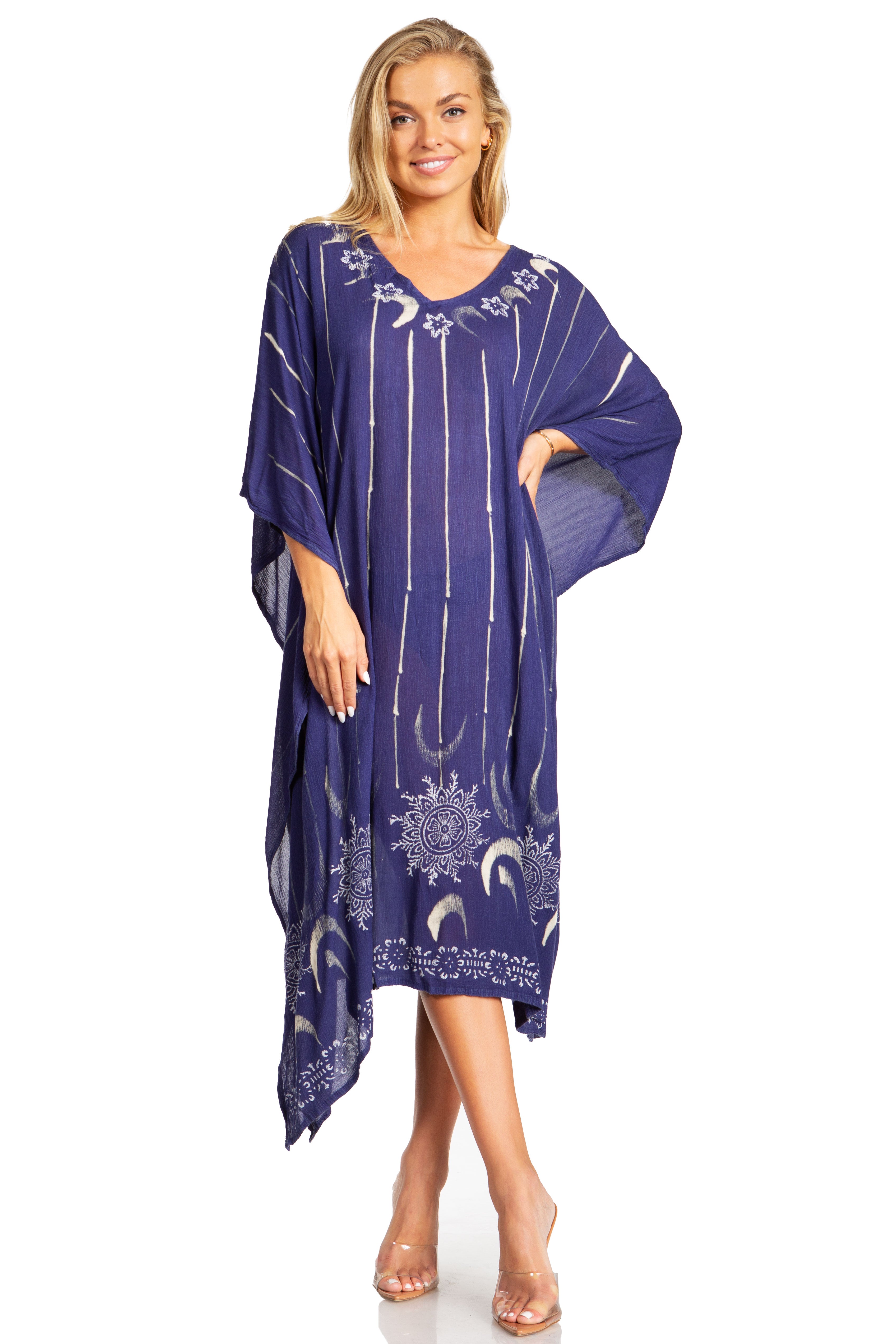 Woman wearing a blue dress with white patterns on a white background
