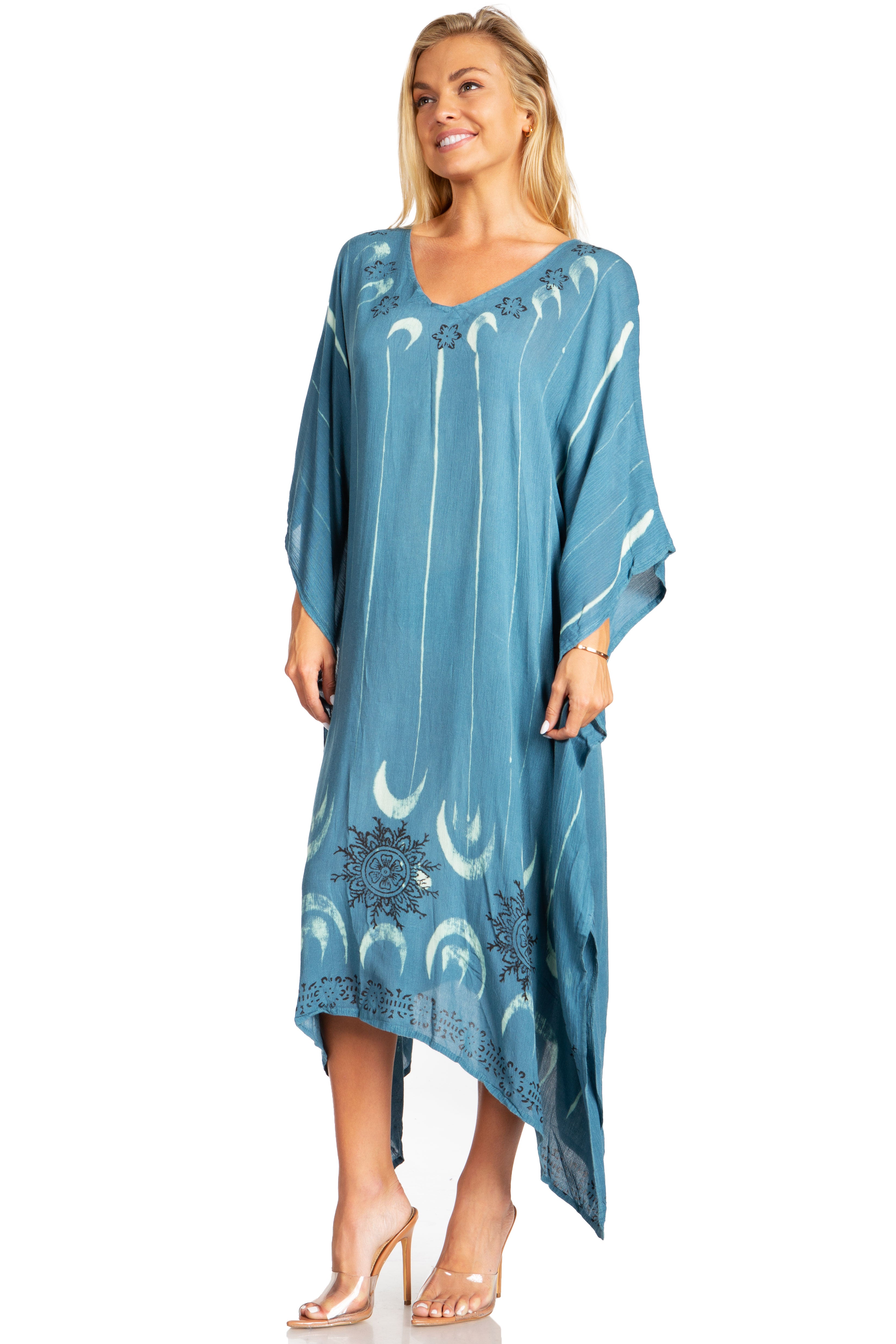 Woman wearing a blue dress with white patterns on a white background