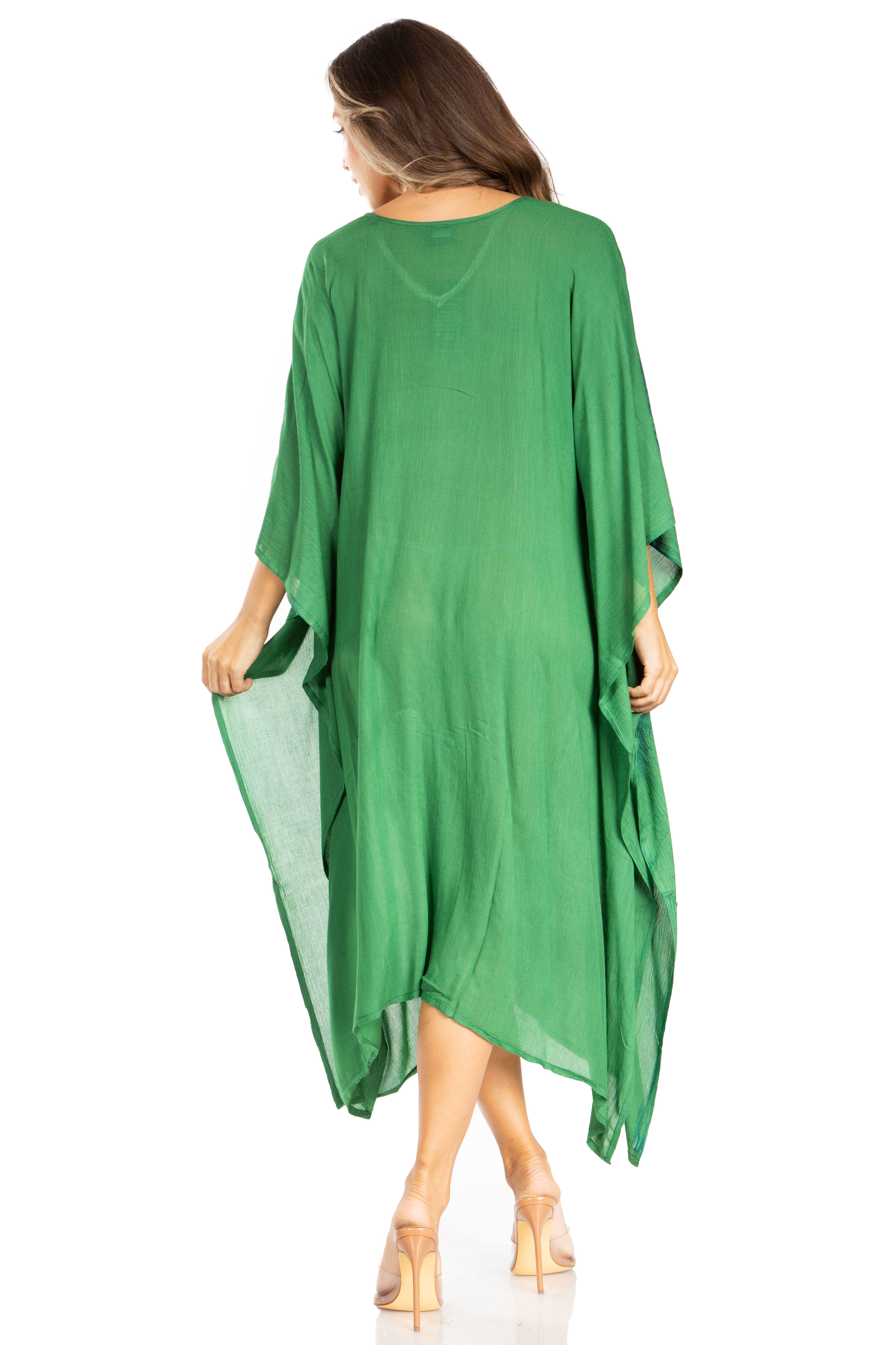 Woman wearing a green dress with sheer overlay on a white background
