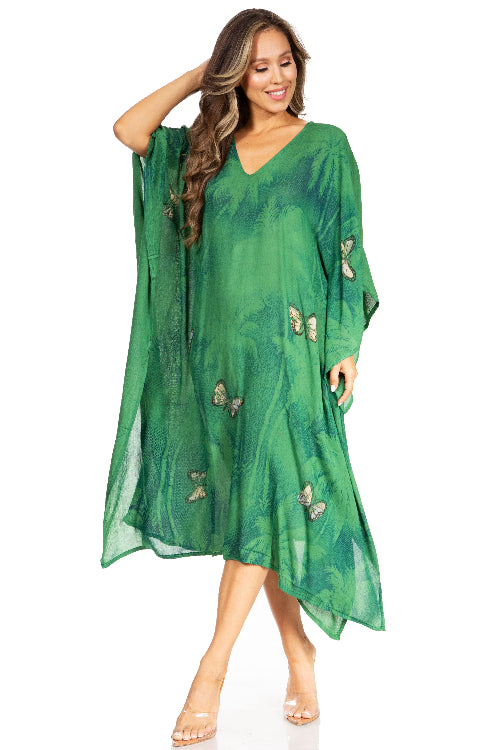 Woman wearing a green dress with butterfly patterns on a white background
