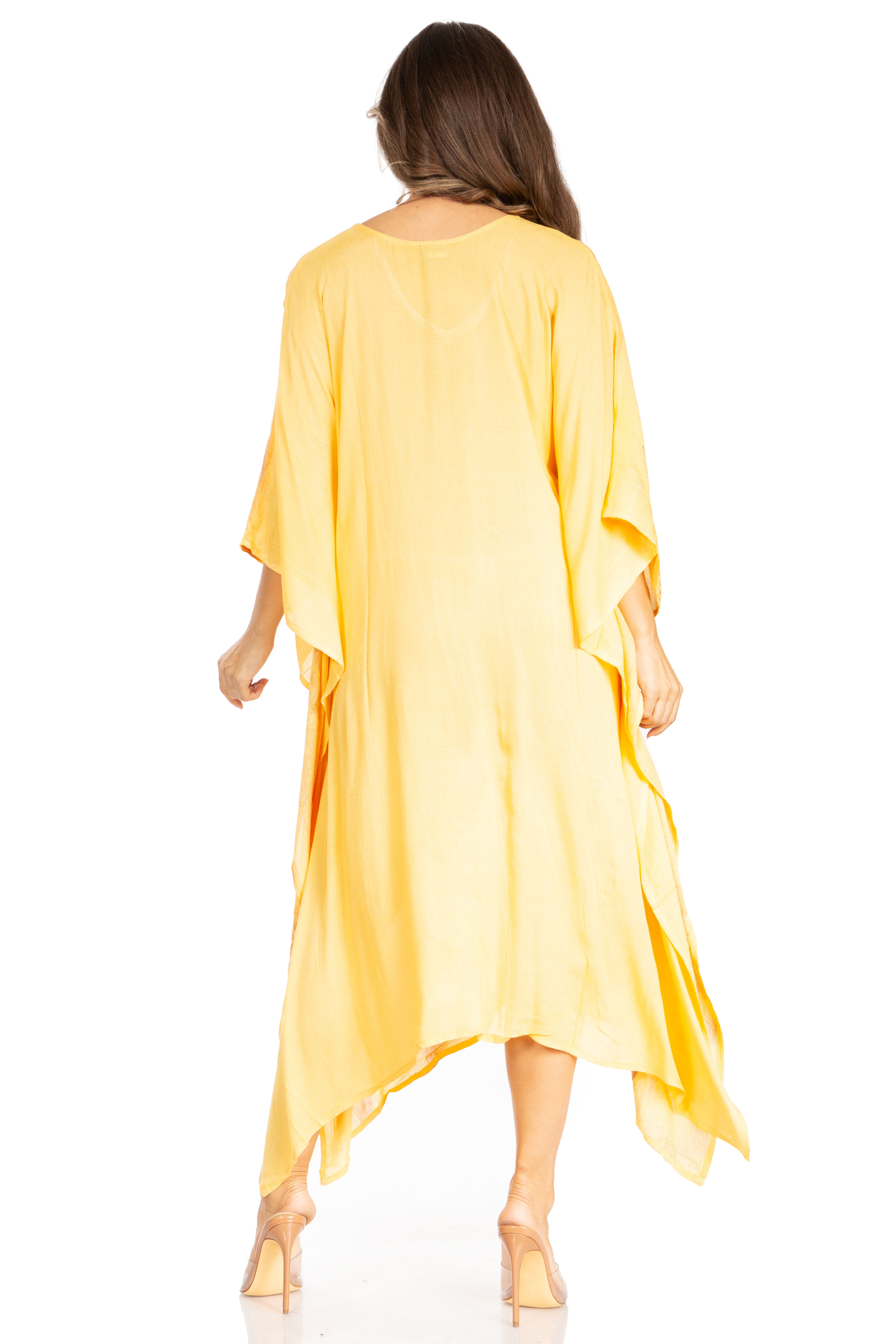 Woman wearing a yellow dress with a plain background