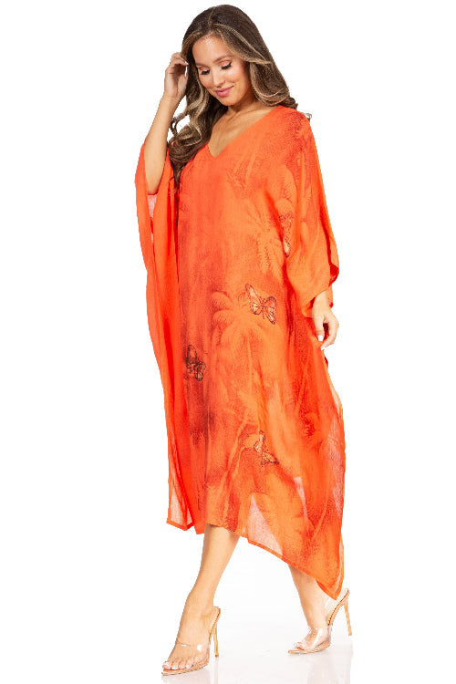 Woman wearing an orange kaftan with butterfly designs on a white background