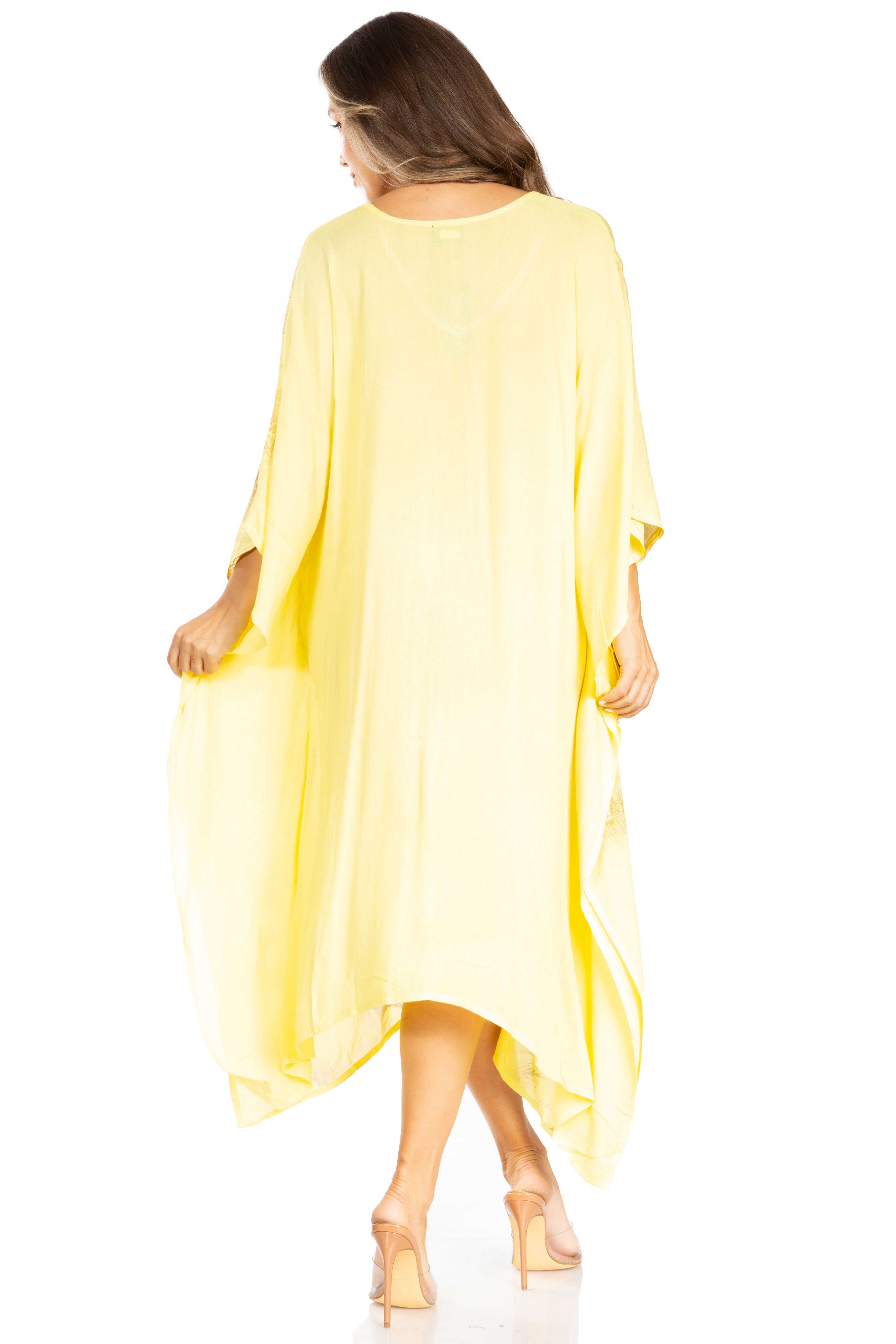 Woman wearing a yellow dress with long sleeves on a white background