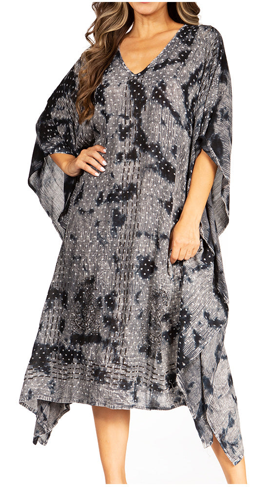 Woman wearing a gray patterned dress with a white background