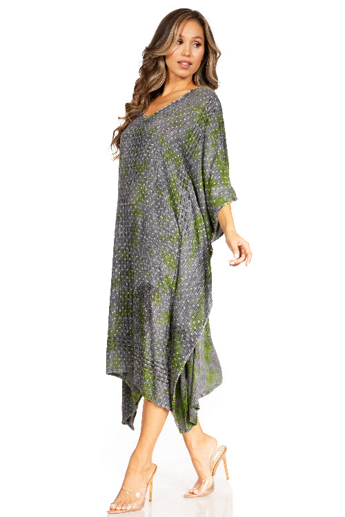 Woman wearing a gray and green patterned dress on a white background