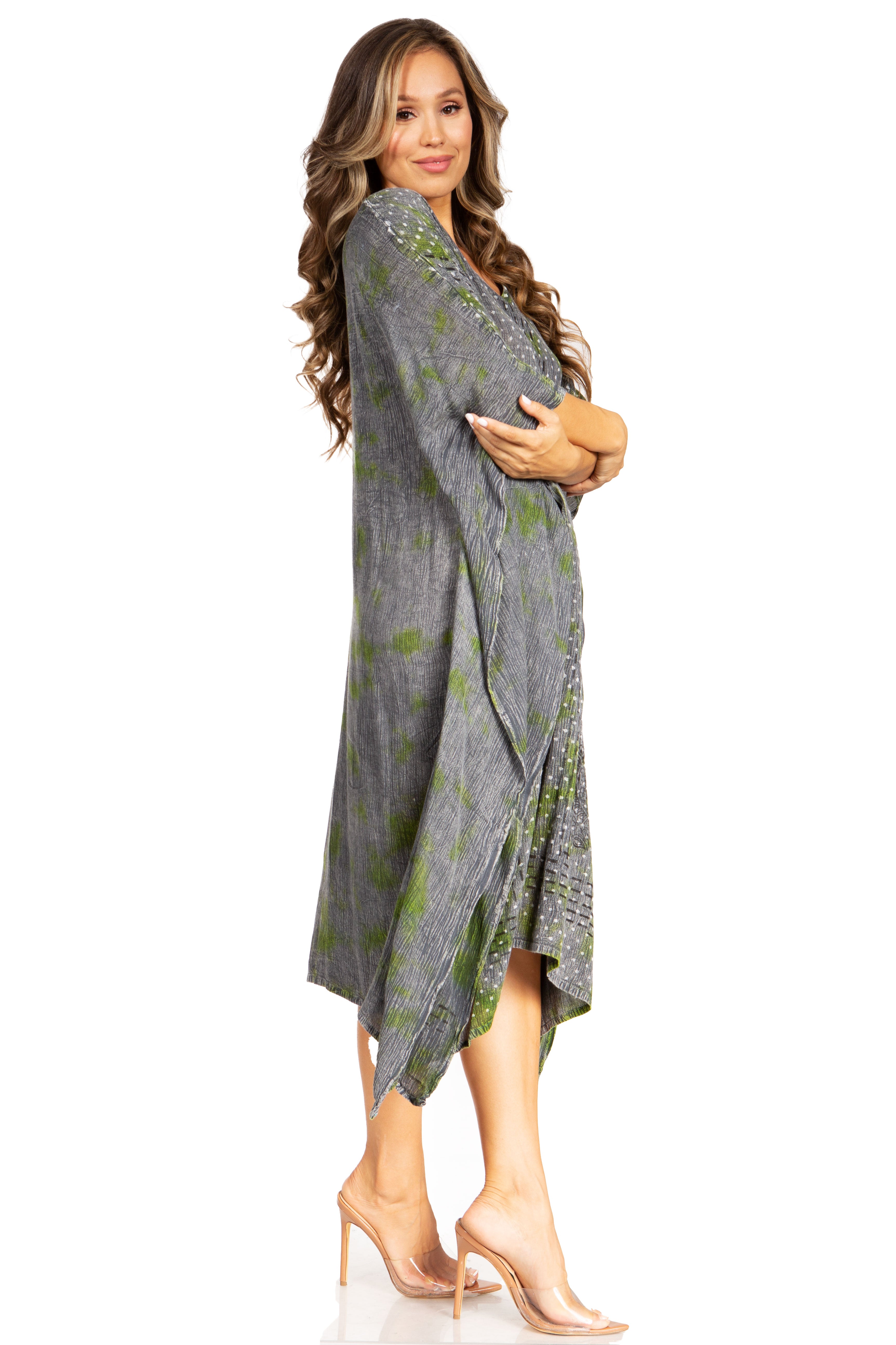 Woman wearing a gray and green patterned dress on a white background