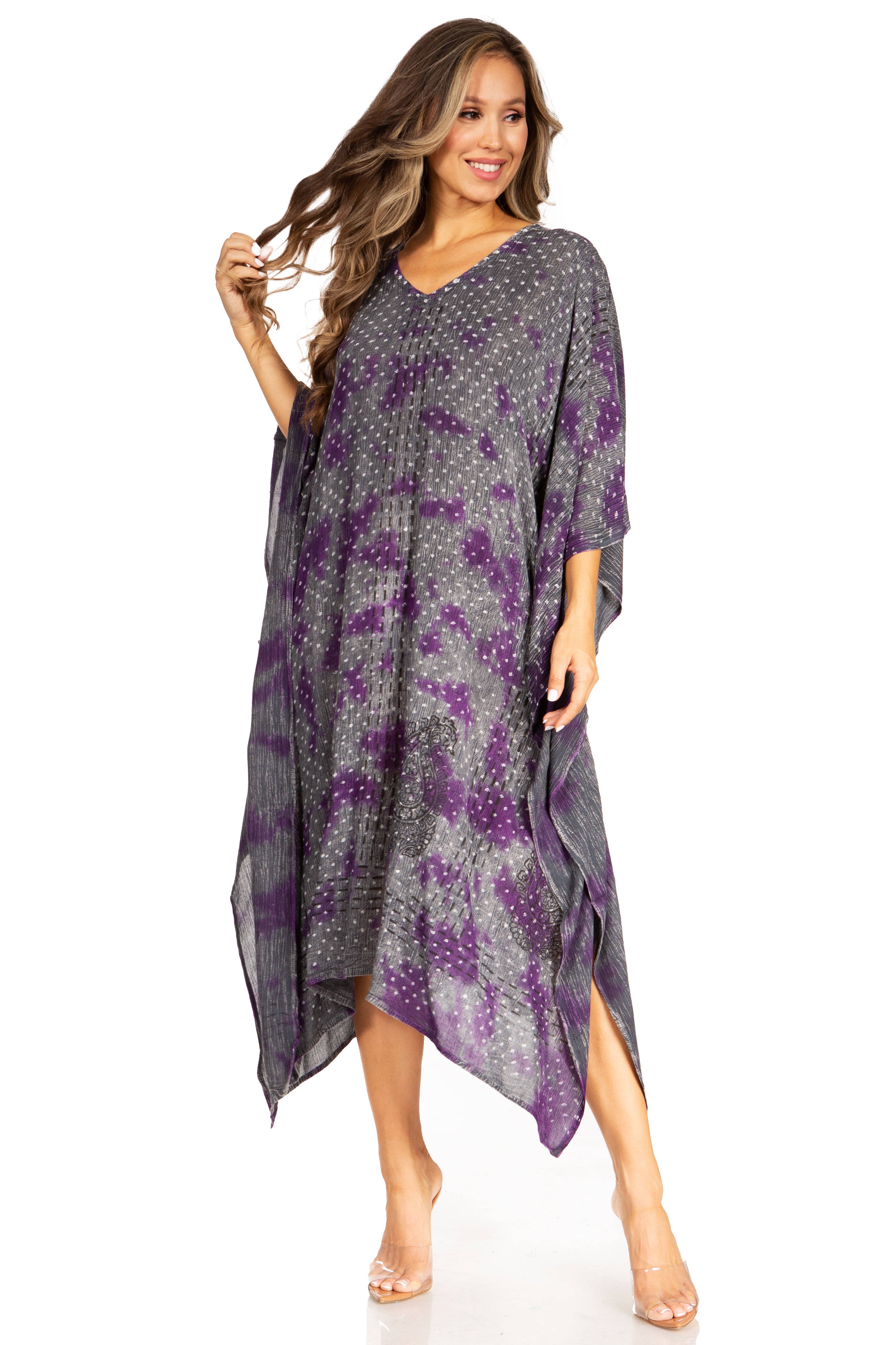 Woman wearing a gray and purple patterned dress on a white background