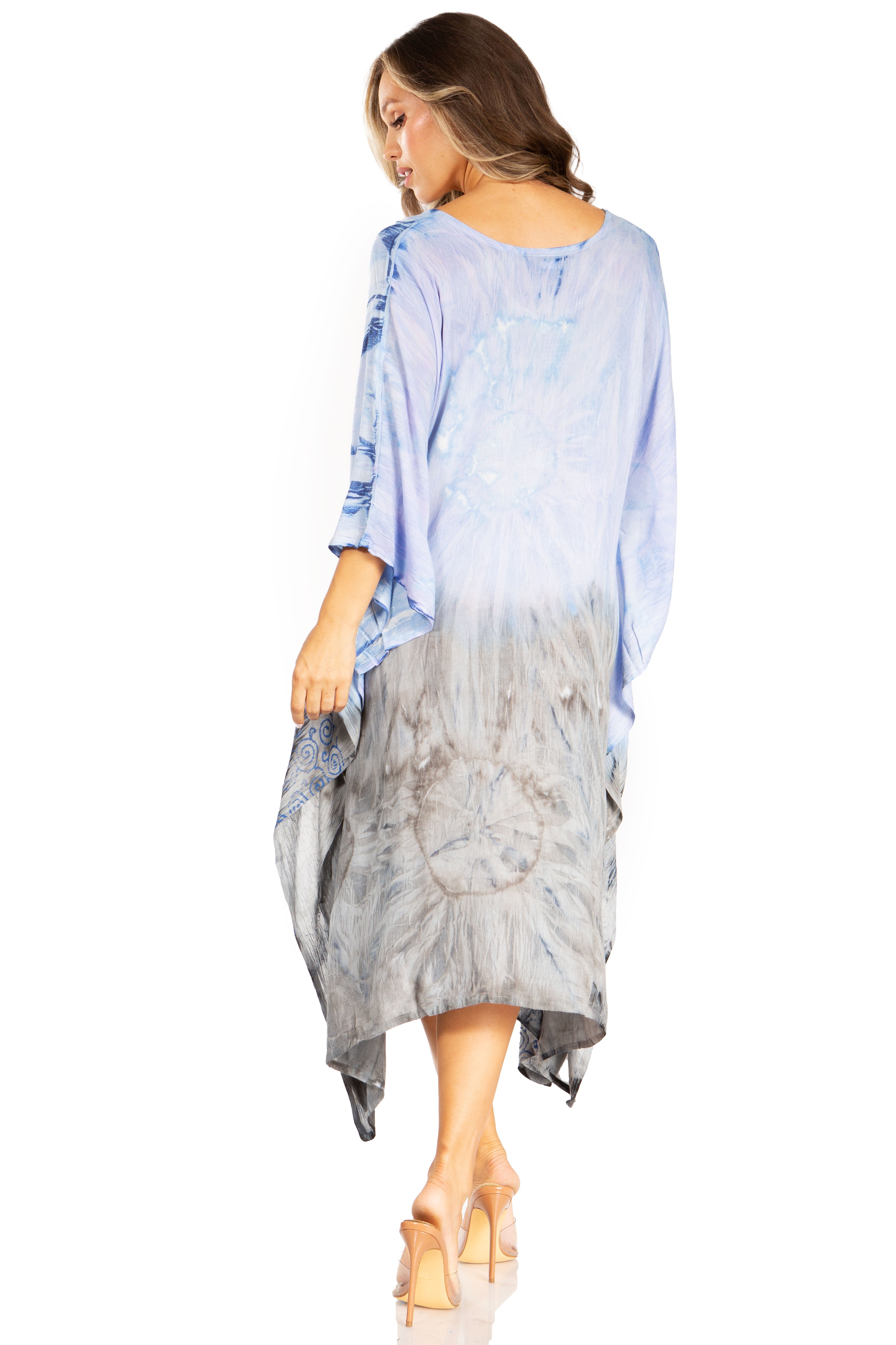 Woman wearing a light blue and gray dress with a white background