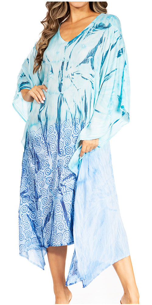 Woman wearing a blue patterned dress with a white background