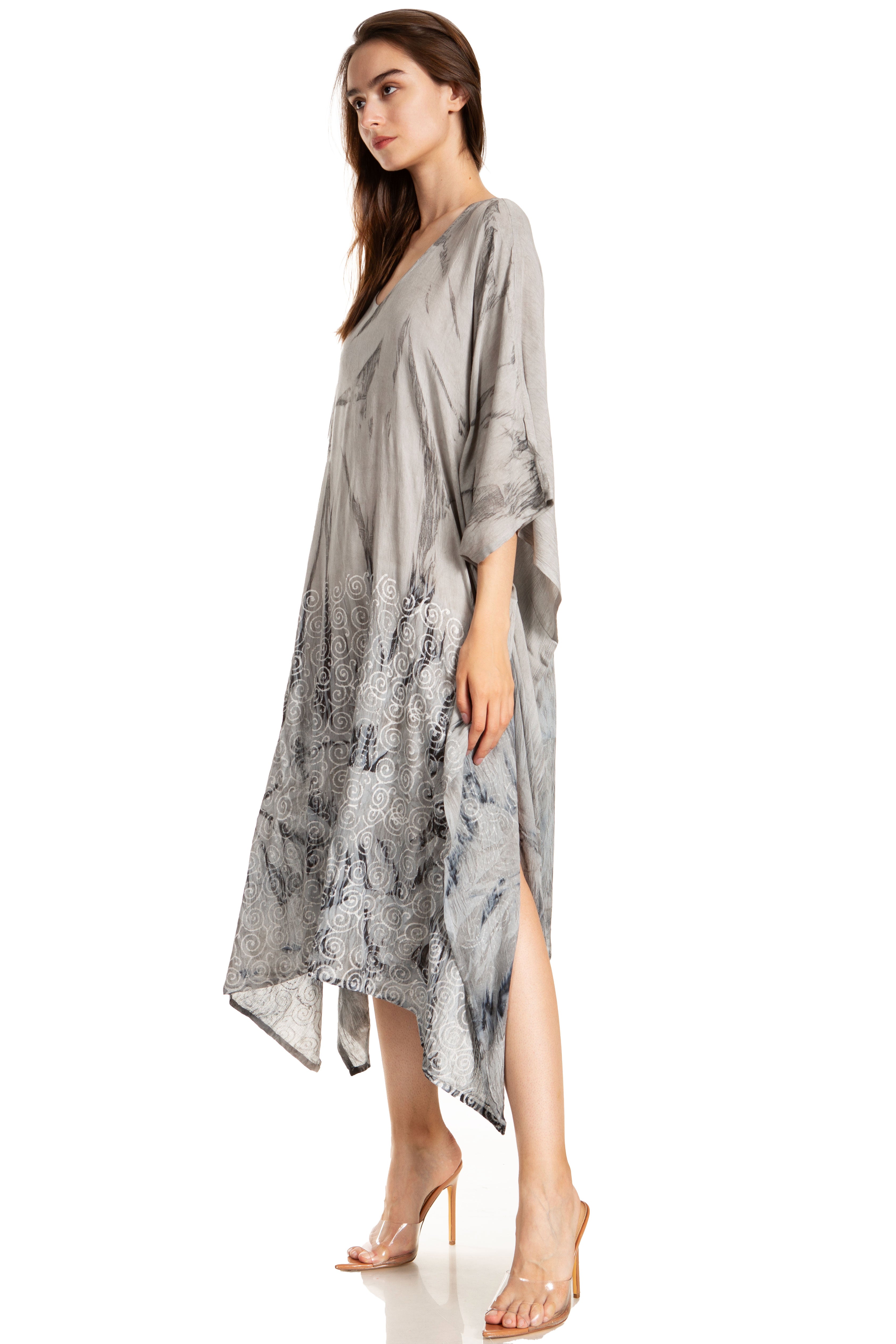 Woman wearing a gray patterned dress on a white background