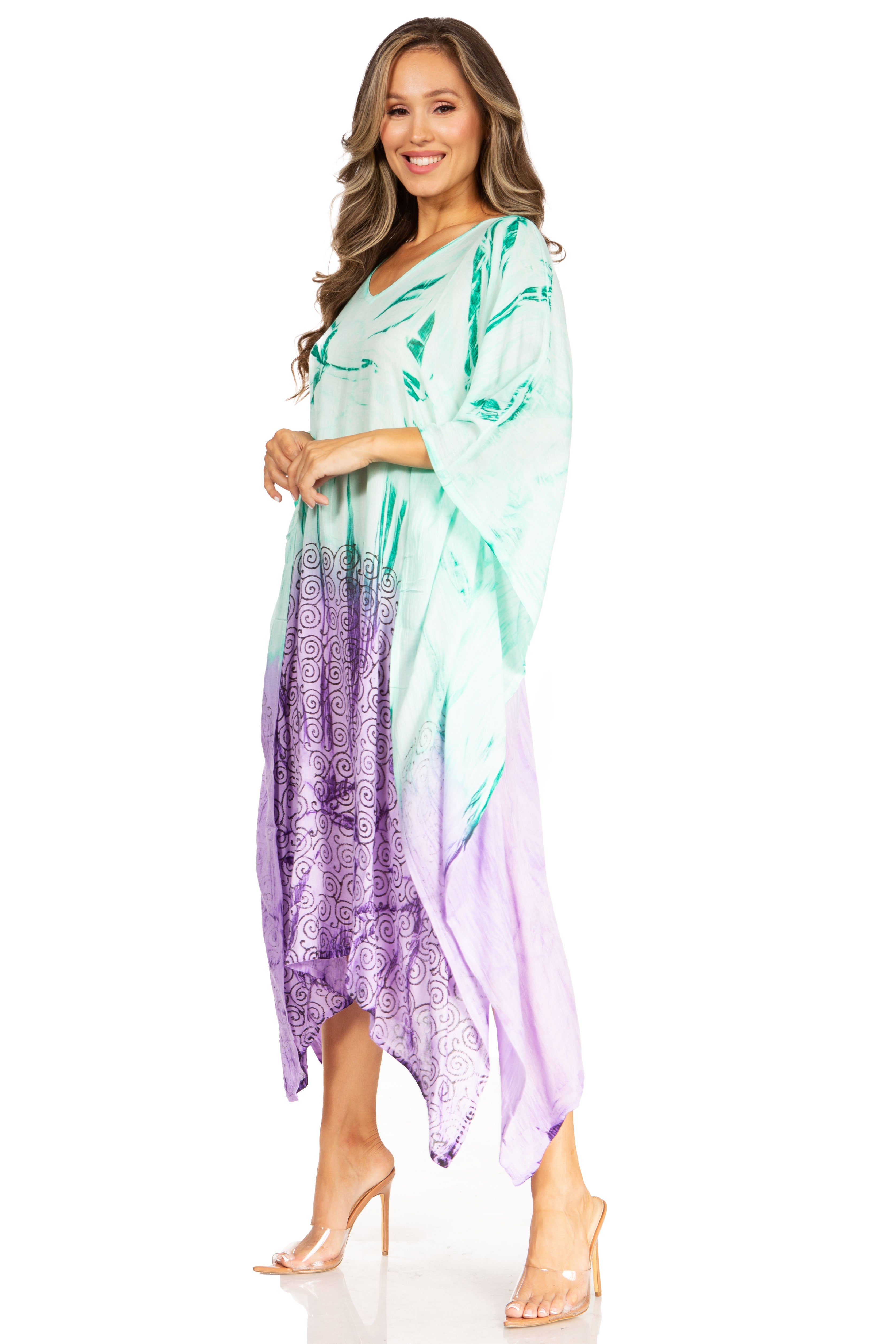 Woman wearing a colorful dress with a gradient from green to purple on a white background