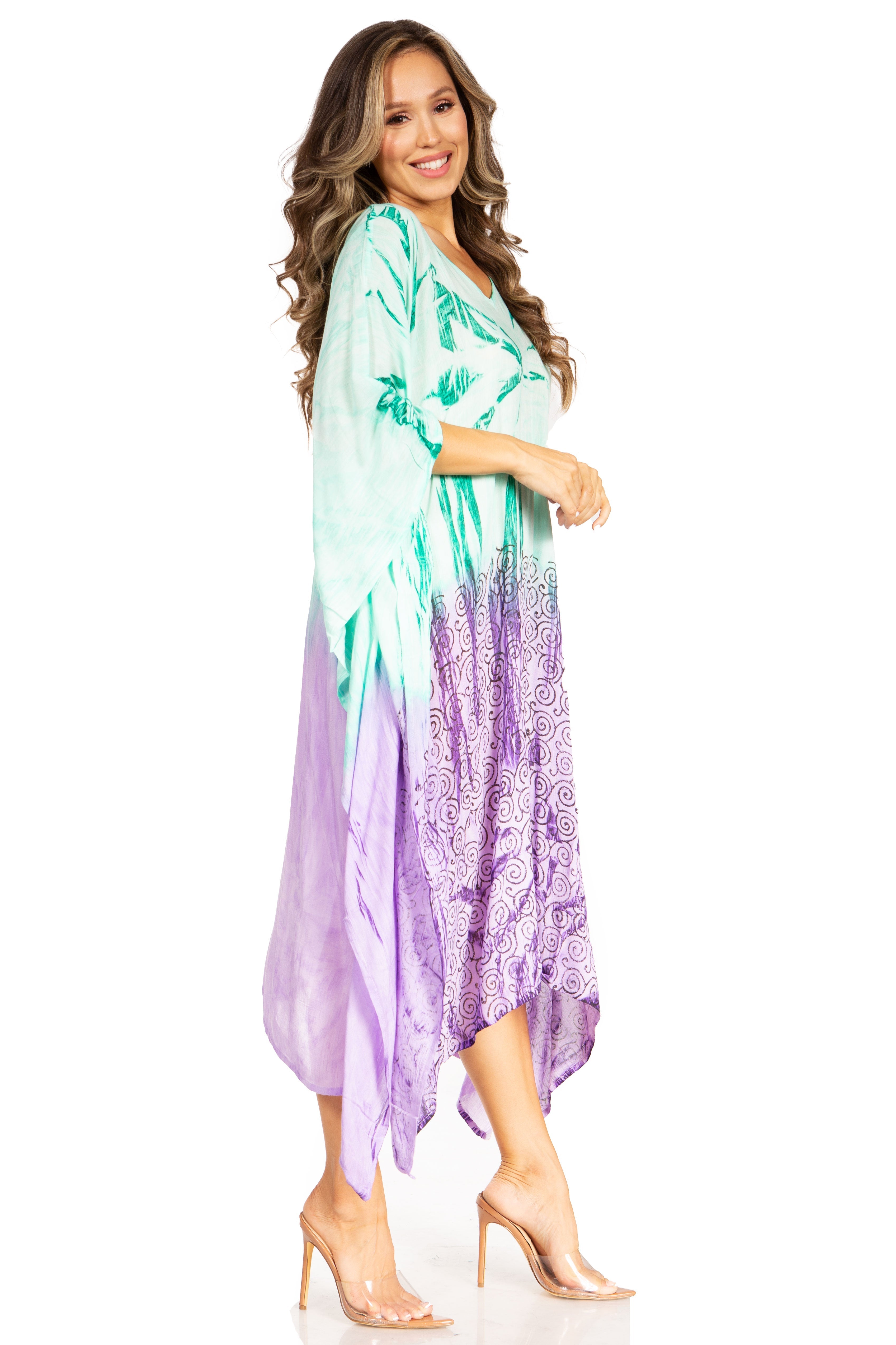 Woman wearing a colorful dress with a gradient from green to purple on a white background