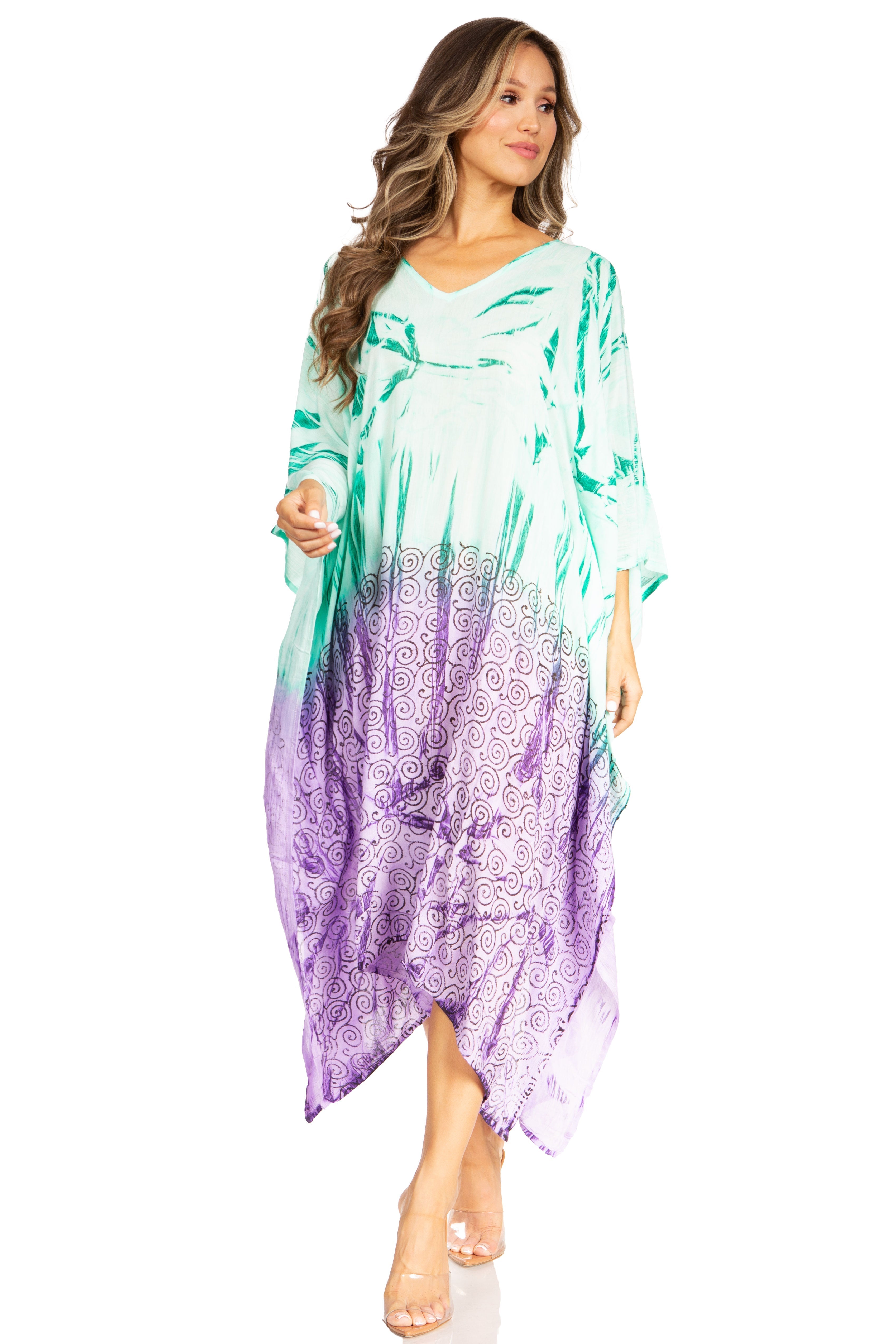 Woman wearing a colorful dress with a gradient from green to purple on a white background