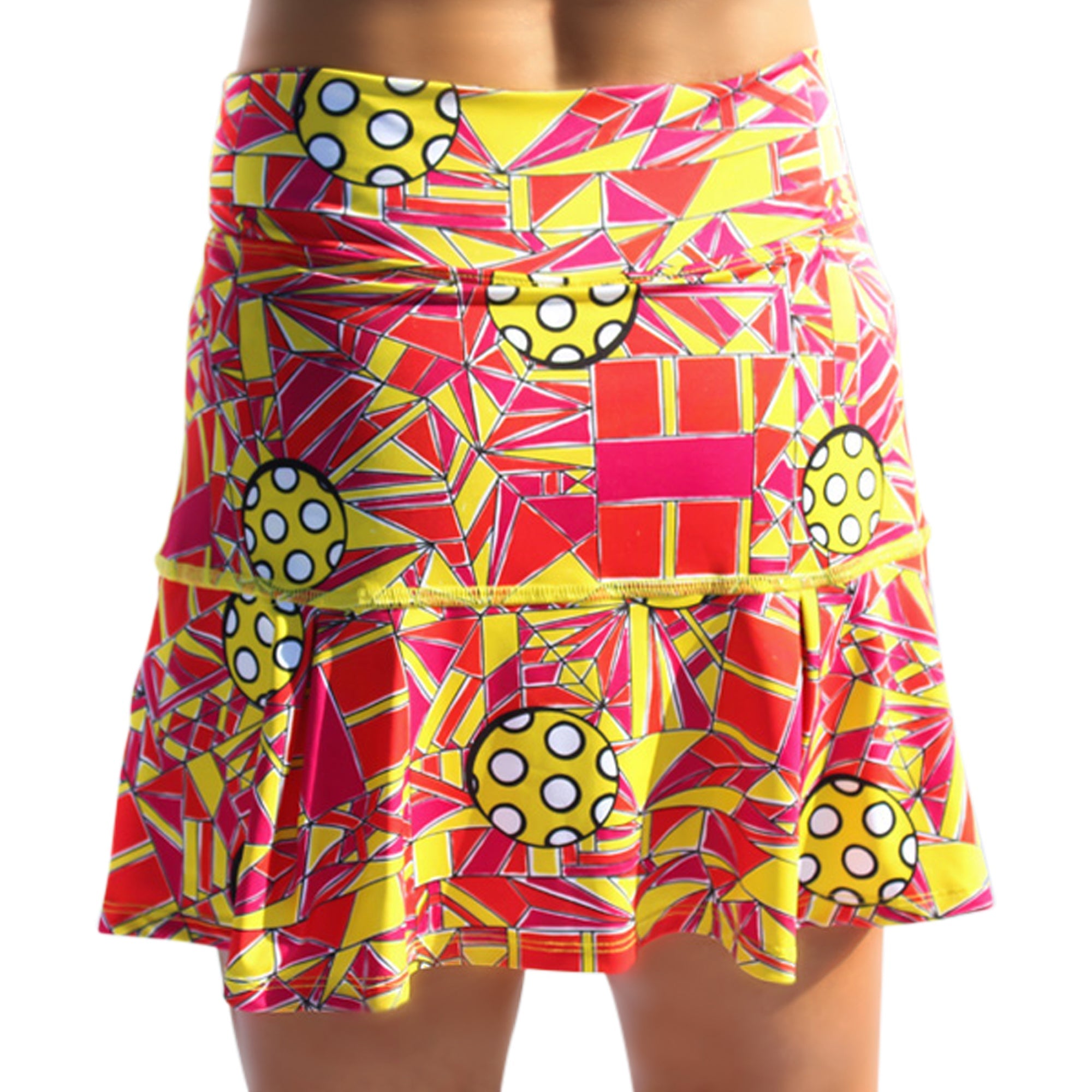 Colorful geometric patterned skirt with polka dot accents on a white background