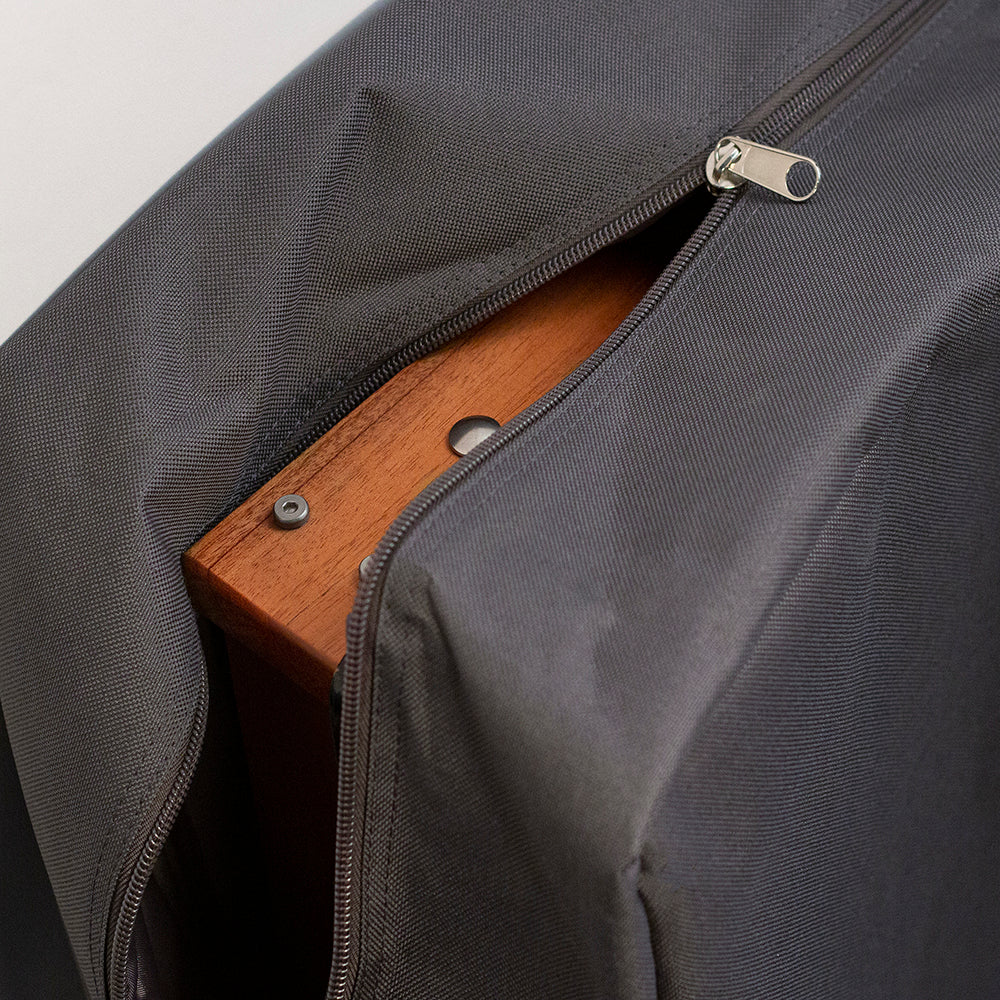 Gray bag with a wooden handle peeking out
