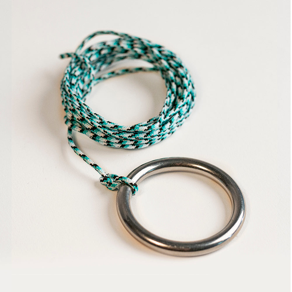 Bracelet with braided design and metal ring on a white background
