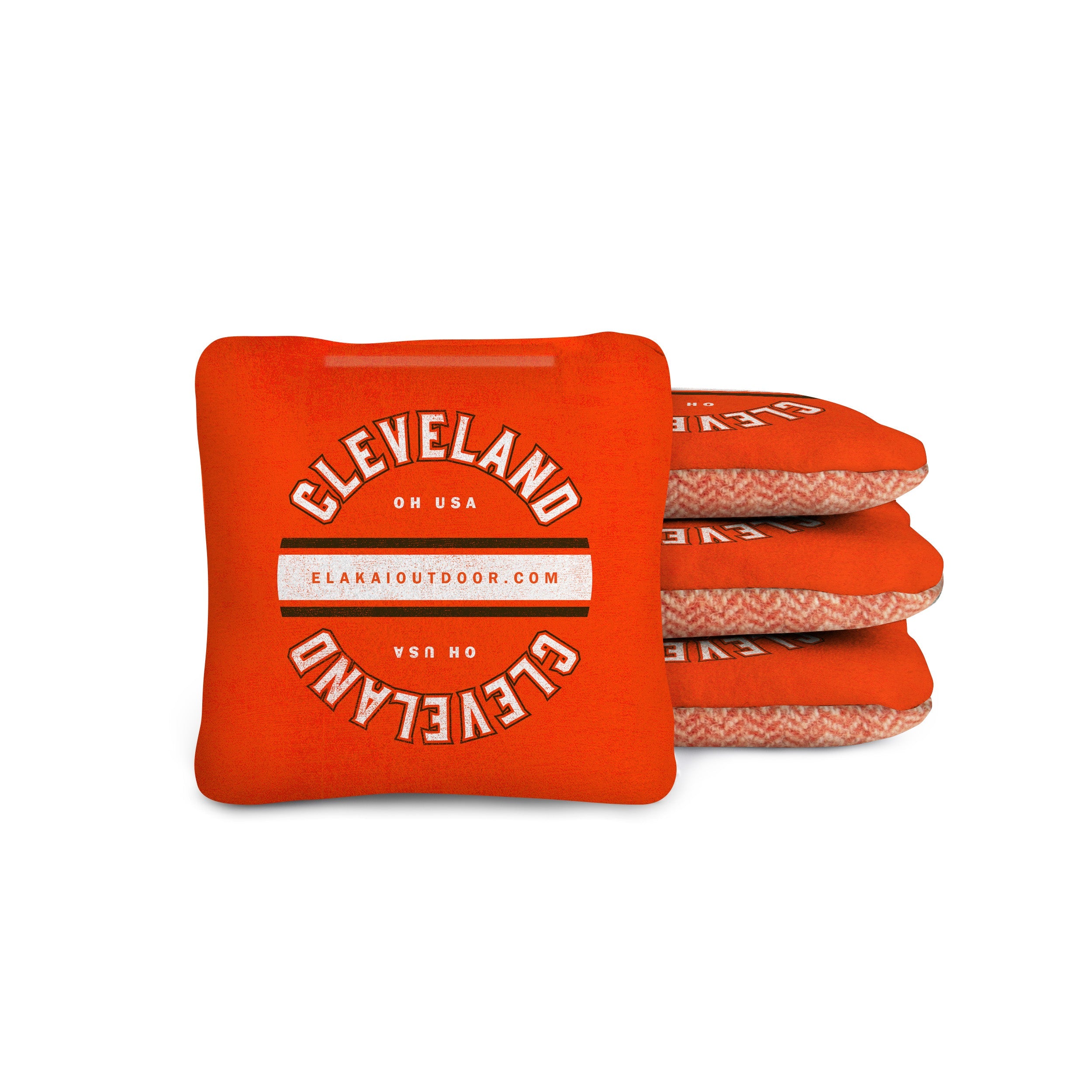 Stack of orange cornhole bags with 'Cleveland' and 'USA' text on a white background