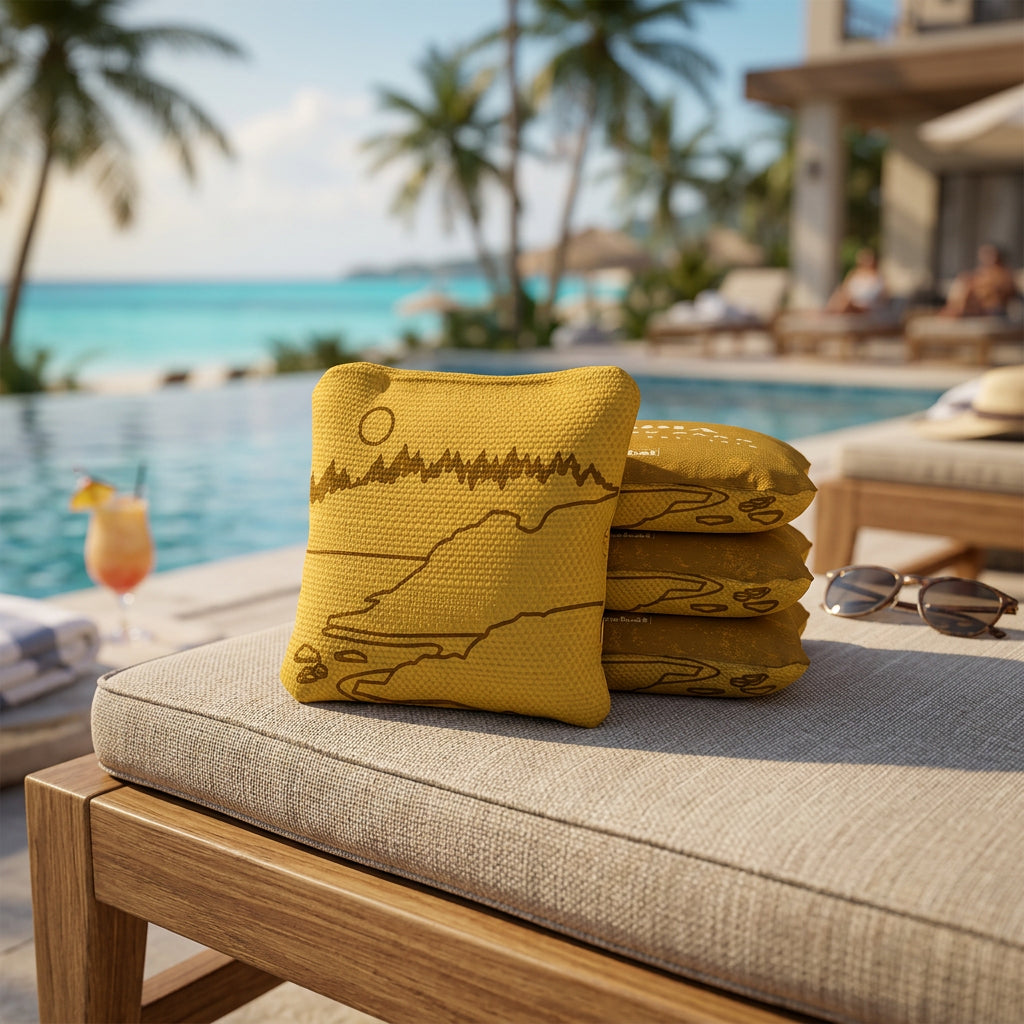 Yellow cornhole bags with a design on a white background