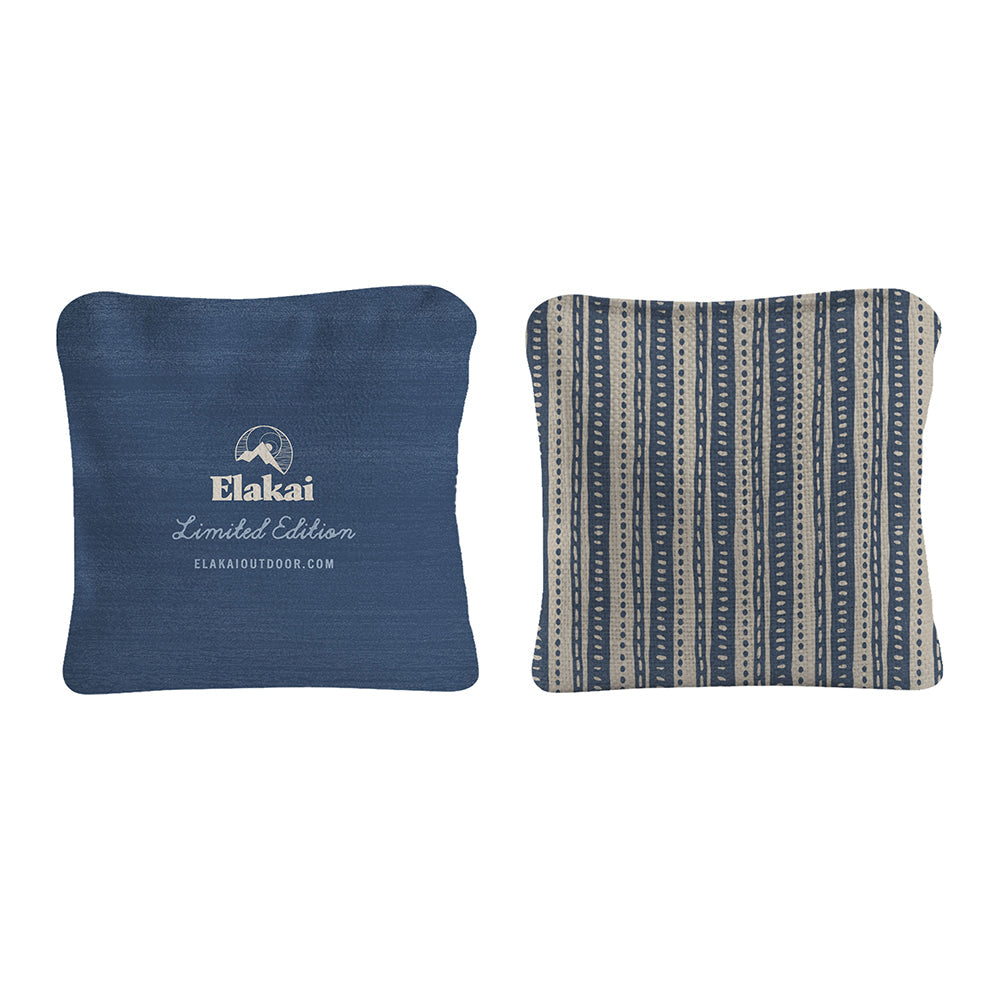 Two blue pillows, one with a logo and text, on a white background