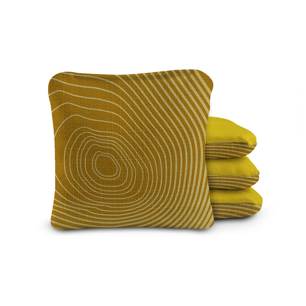 Yellow patterned pillow and folded blanket on a white background