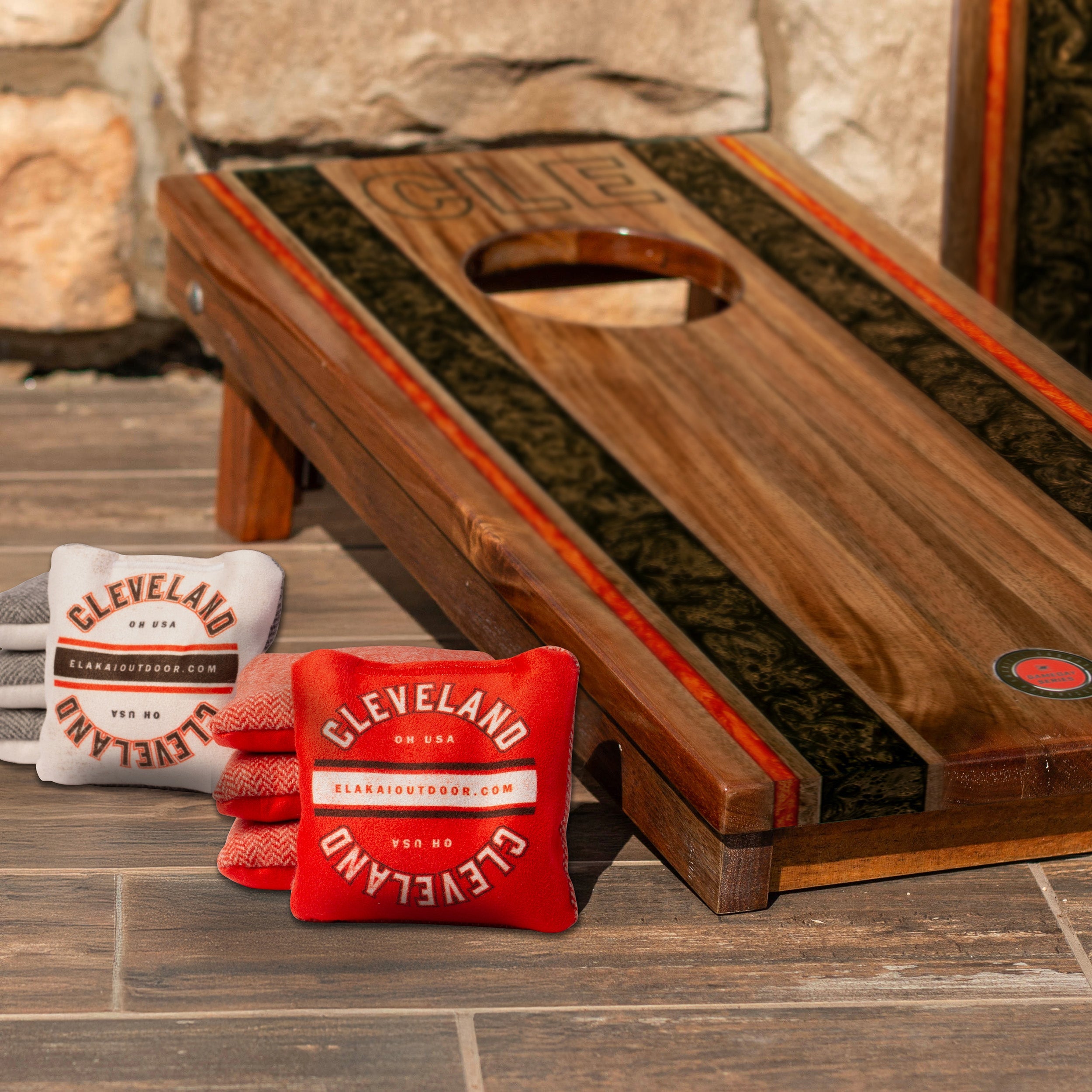Cornhole board with bags featuring 'Cleveland' branding on a wooden surface.