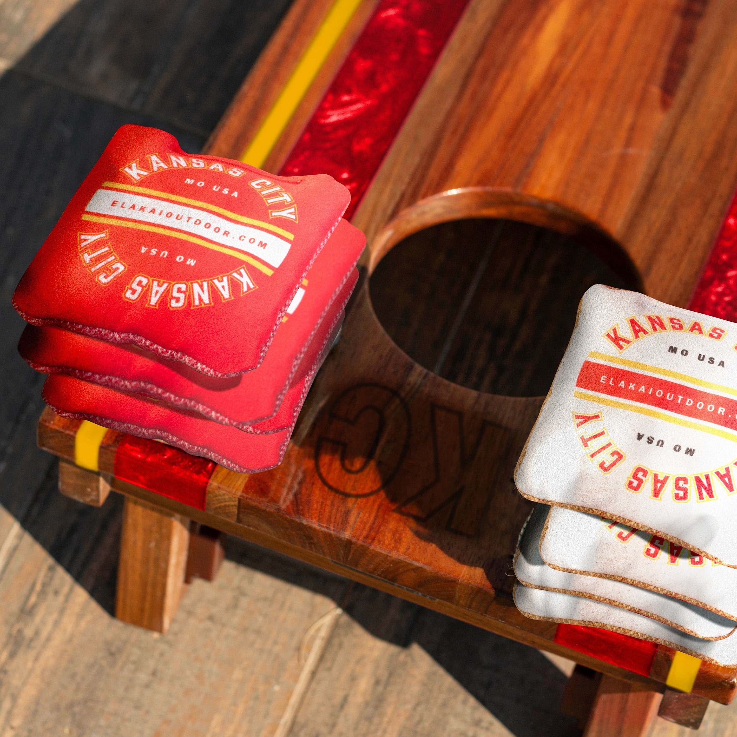 Red and white coasters with 'Kansas City' branding on a wooden holder.