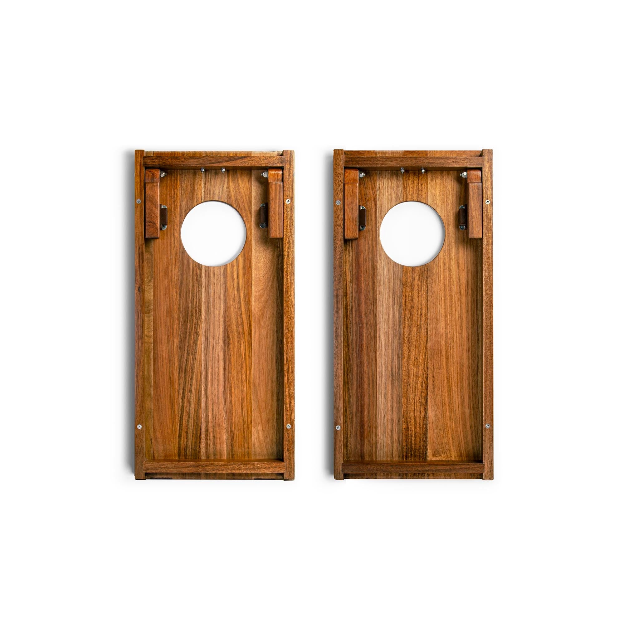 Two wooden cornhole boards with circular holes on a white background