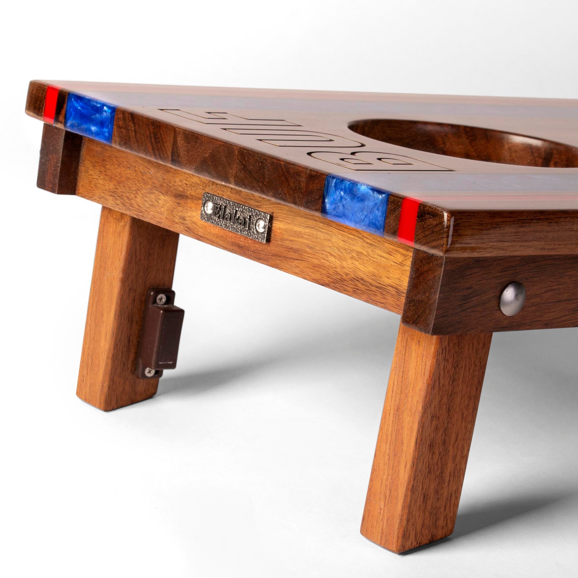 Wooden shuffleboard table with red and blue ends on a white background
