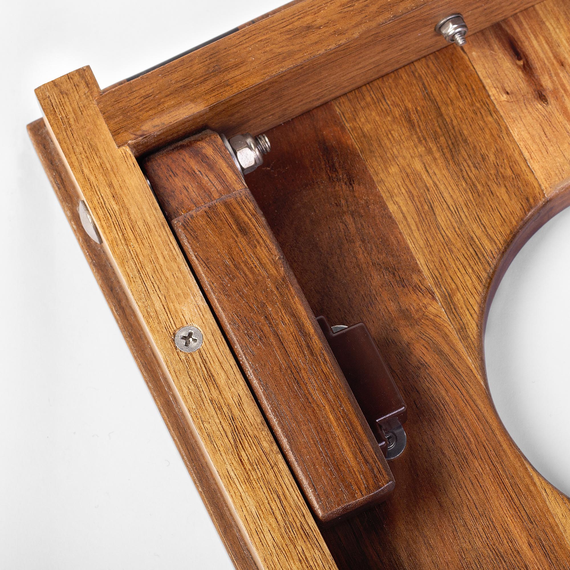 Close-up of a wooden product with metal components on a white background