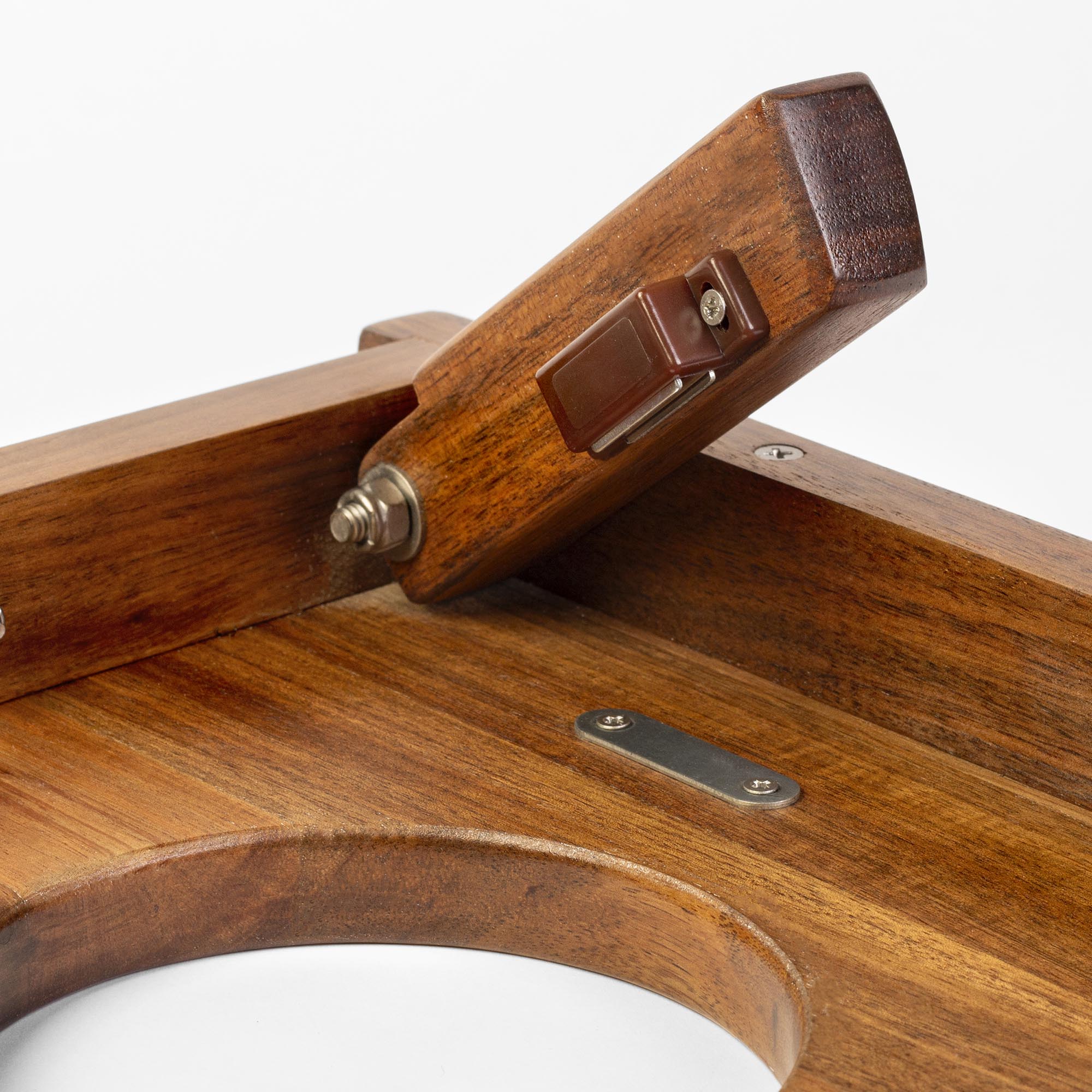 Close-up of a wooden product with metal components on a white background