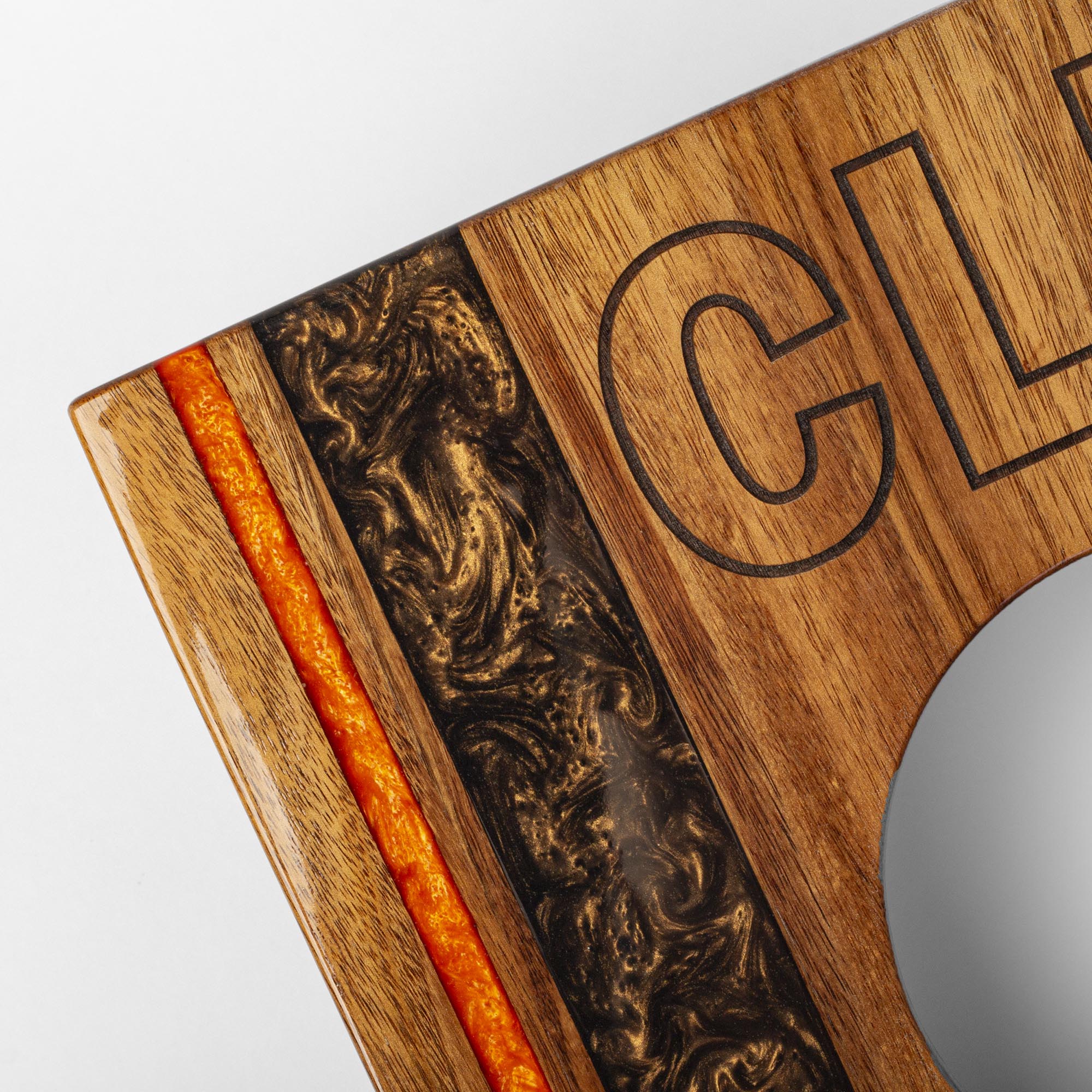 Wooden cutting board with engraved design and 'CL' initials on a white background